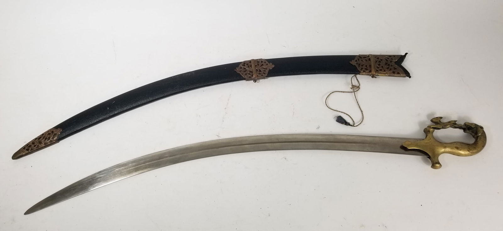 Vintage Medieval Style Saber Sword with Sheath: Vintage Medieval Style Saber Sword with SheathSize35" HLiteratureBrooks Auction – Online Auction Terms & Conditions Contact: (856) 694-2960 | info@brooks.auction READ BEFORE YOU BID: We want
