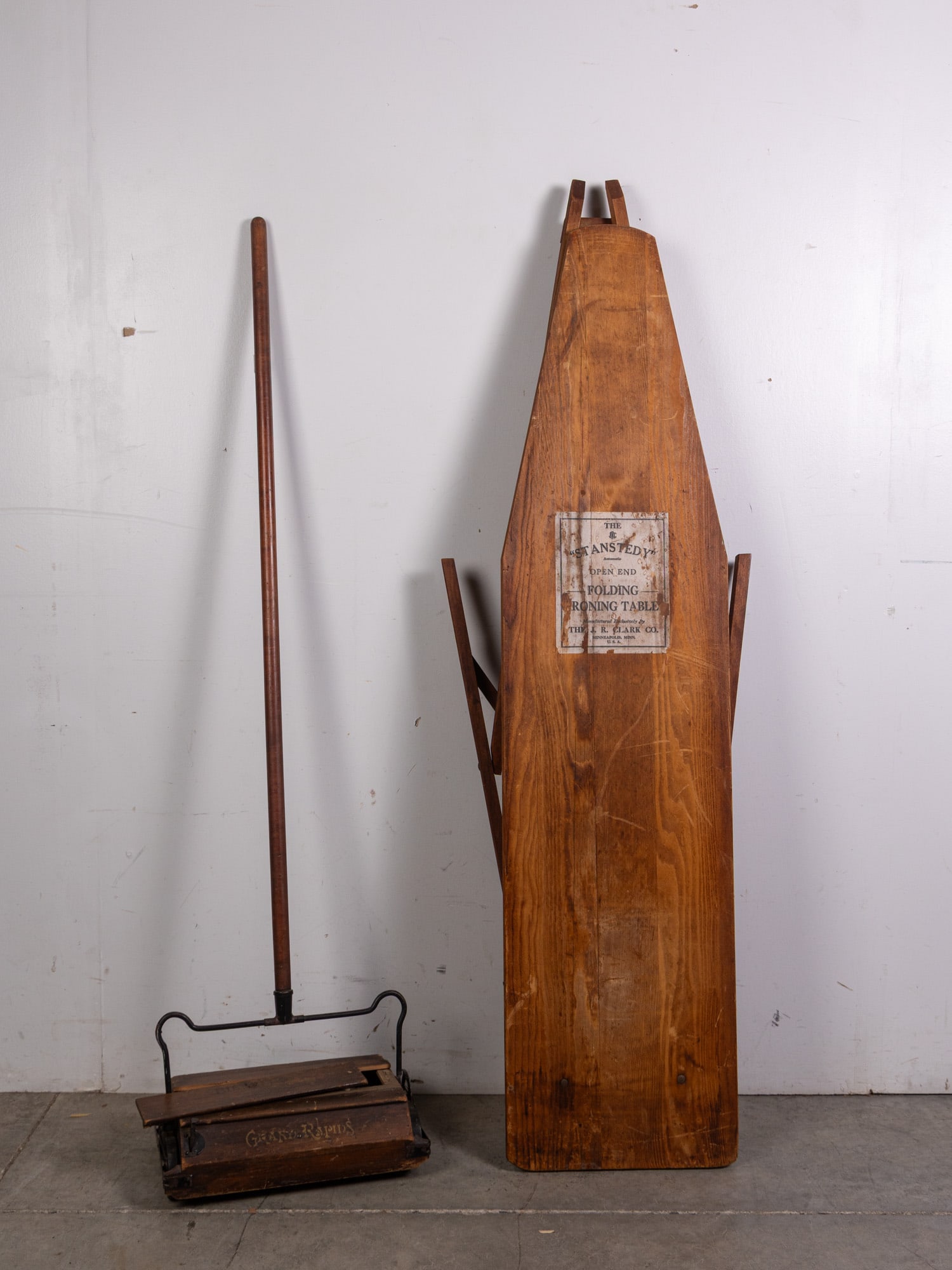 Antique Vacuum and Ironing Board: Antique Vacuum and Ironing Board: "Stansteady" Folding Ironing Table by the J.R. Clark Co. and early Bissell vacuumSize54" x 13" (ironing board)LiteratureBrooks Auction – Online Auction Terms