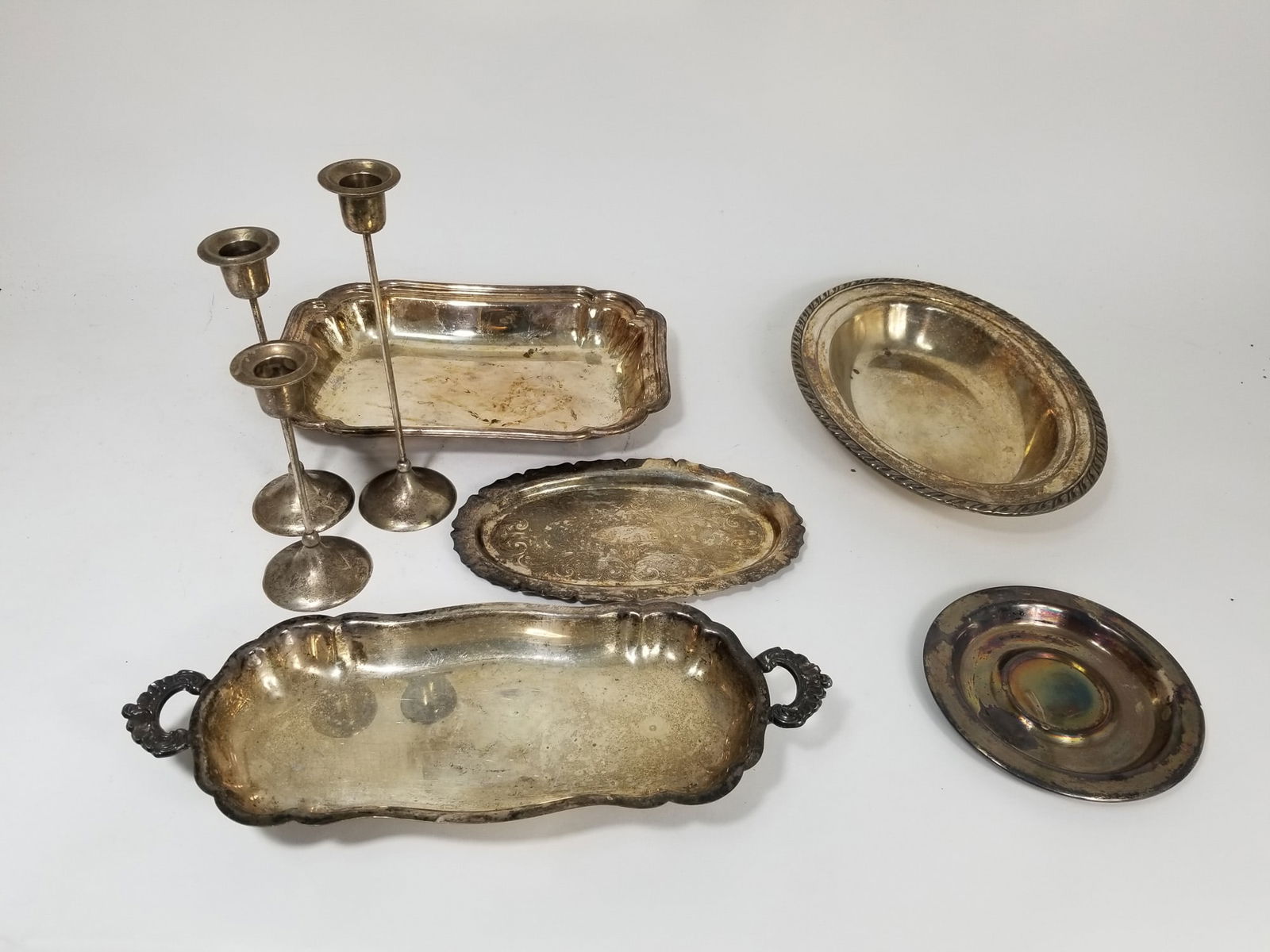 Silver Plate Lot - Trays and Candle Sticks: Silver Plate Lot - Trays and Candle SticksLiteratureBrooks Auction – Online Auction Terms & Conditions Contact: (856) 694-2960 | info@brooks.auction READ BEFORE YOU BID: We want you to feel