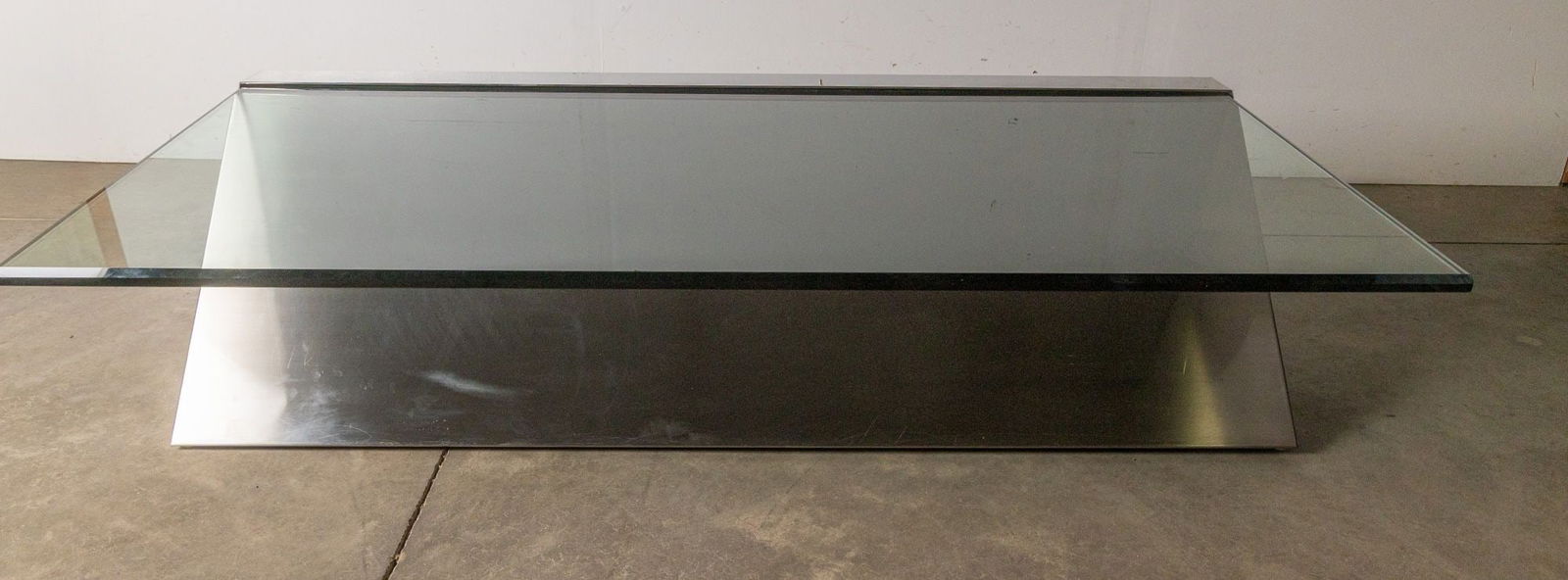 J. Wade Beam | Breuton Cantilever Glass Table: featuring a minimalist chrome cantilever frame paired with a tempered glass top, combining modernist elegance with functional versatility. Its sleek, open design creates a light, airy