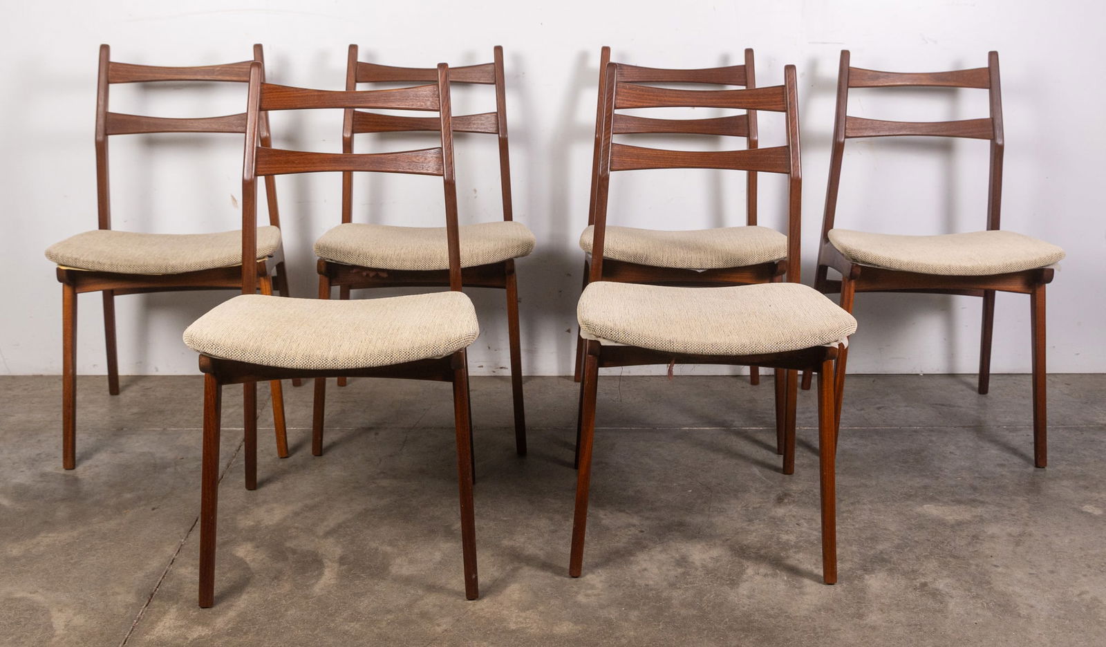 Habeo | (6) Modern "Boomerang" Teak Chairs: With its minimal wool beige upholstery, handcrafted teak constriction and striking modern silhouette, this set of chairs is a prime example of the design foreword sensibilities central to the design p