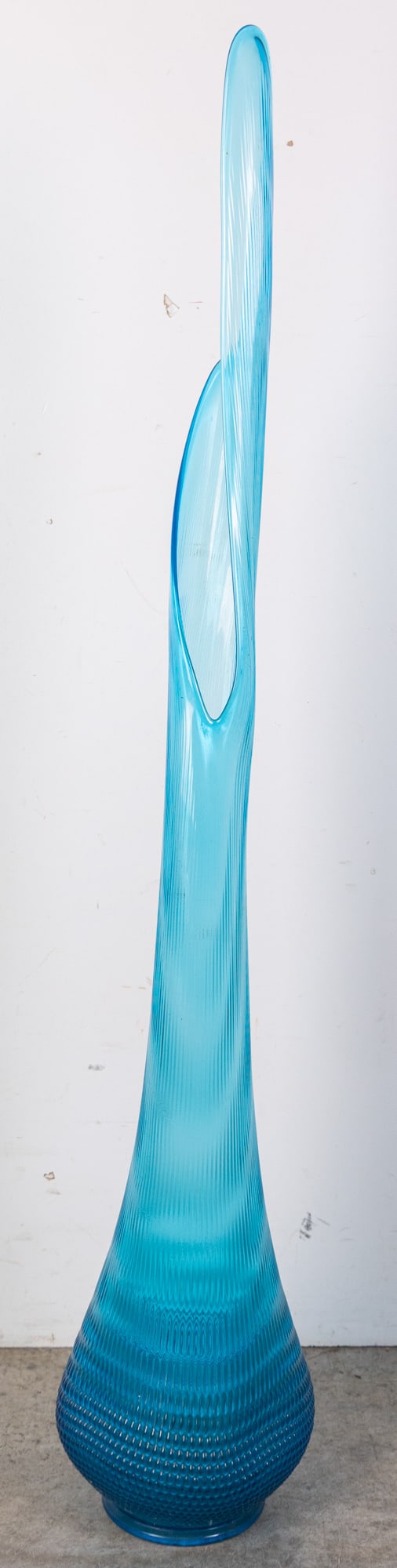 L.E. Smith | Sizeable Mid Century "Nubby Butt" Swung Vase: Nearly four feet in height, this piece of art glass is from the esteemed L.E. Smith Glass Company. This large “Nubby Butt” swung ribbed vase showcases the vibrant, free-form aesthetic of