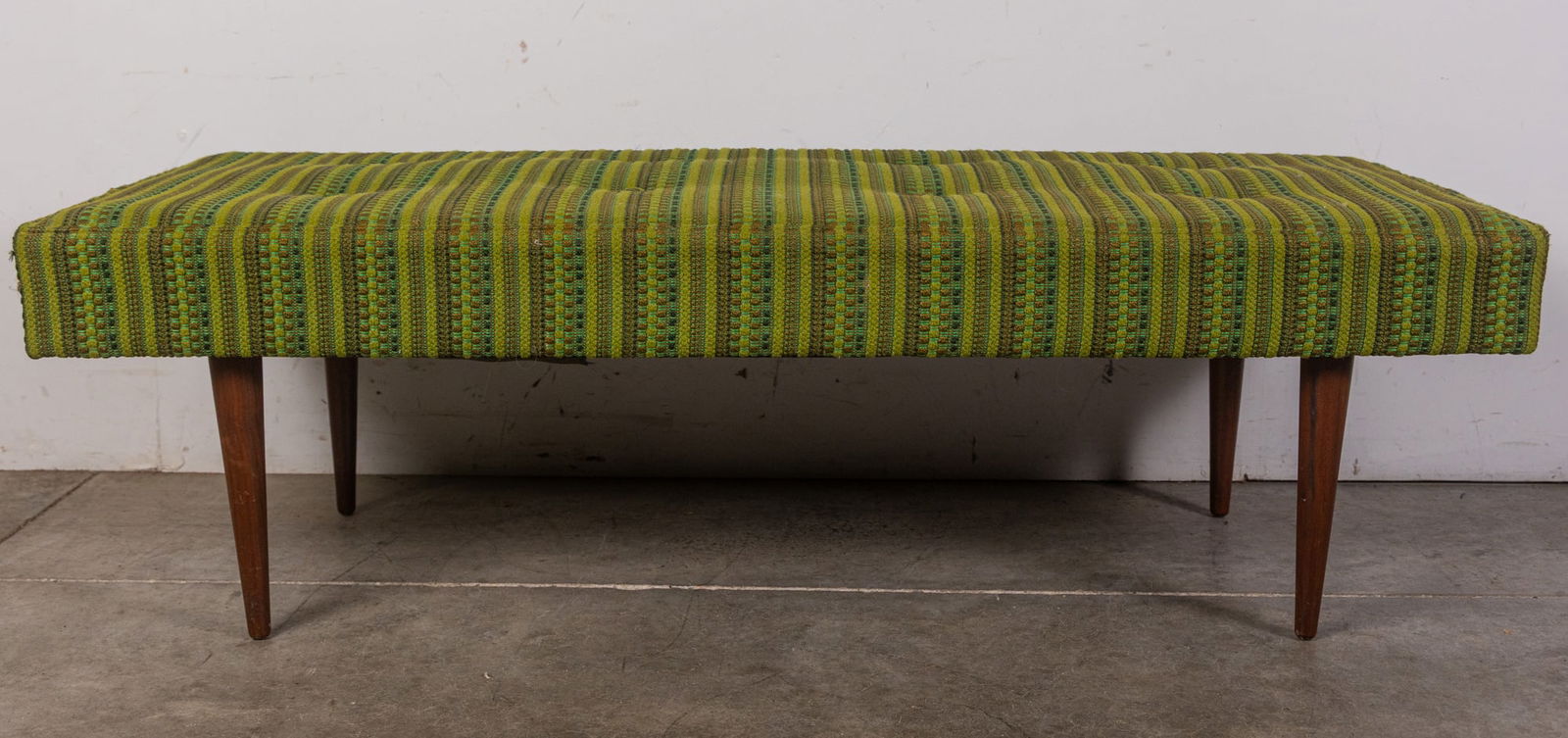 Milo Baughman (1923-2003) | Thayer Coggin Modern Upholstered Bench: Upholstered in bold mossy forest floor green tones with tapered walnut legs. In excellent condition and retaining all of its original retailer & manufacturer tags. Size 15" x 49" x 19" Literature Broo