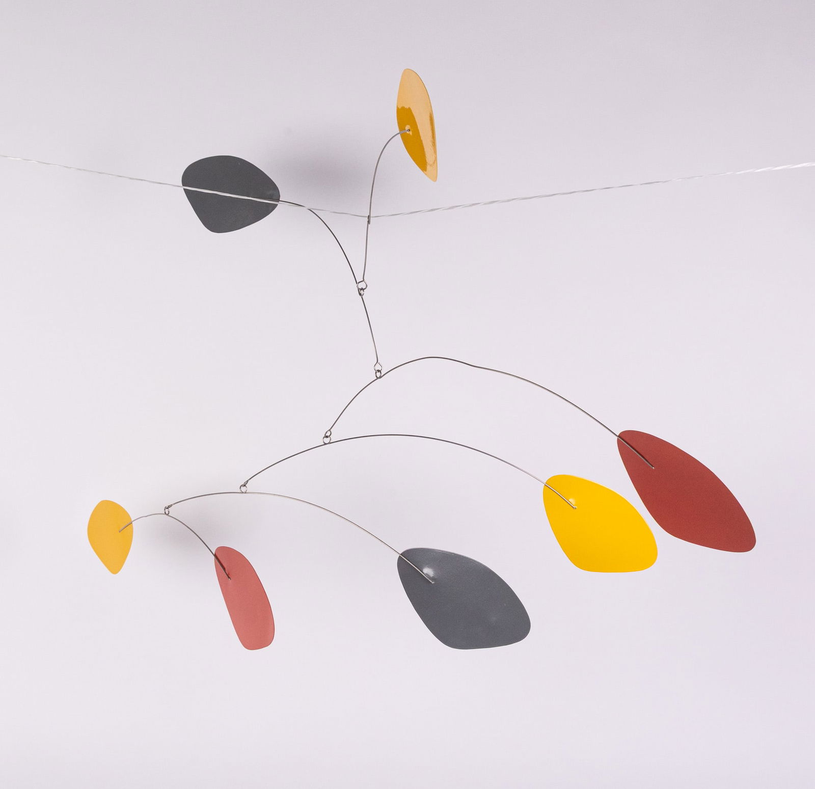 Alexander Calder Style Kinetic Mobile Sculpture: Likely a contemporary piece, this elegant mobile follows in the footsteps of Alexander Calder, an artist most known for his unique hanging mobiles. It features a thin chrome skeleton with red,