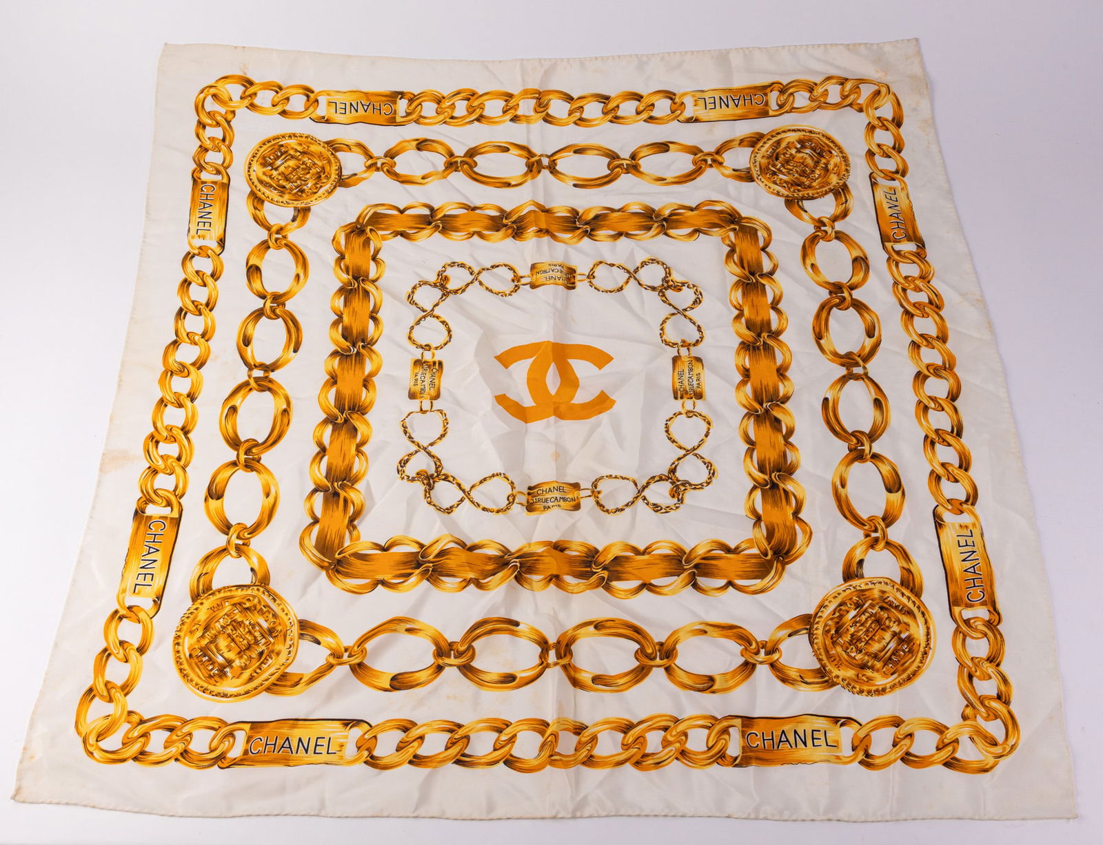 Chanel | 31 Rue Cambon Silk Stole: This beautiful chain link scarf features the Iconic CC logo and a gold chain motif. Condition is consistent with a vintage piece of its age, with minor spots which are pictured.Size34" x