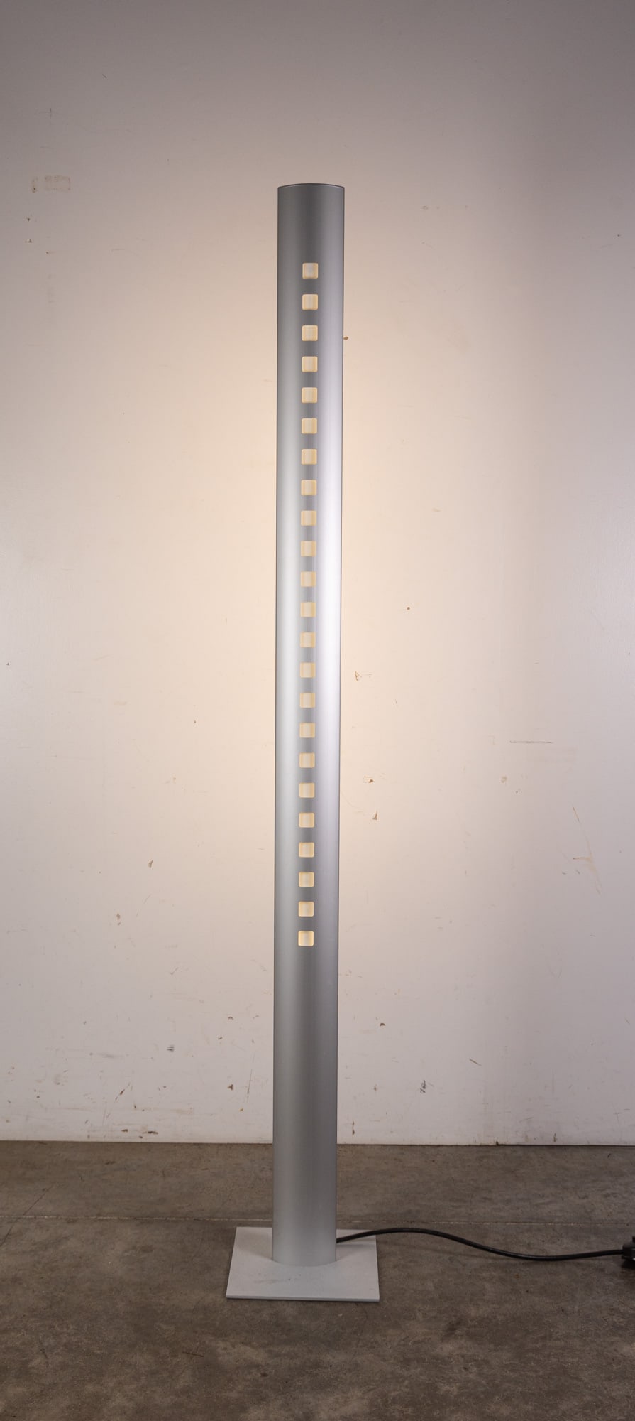 Ligne Roset | Extensia Floor Lamp: Finished in brushed aluminum, its streamlined silhouette delivers a polished, modern presence. Designed with adjustable, directional lighting, the Extensia offers both functional illumination and