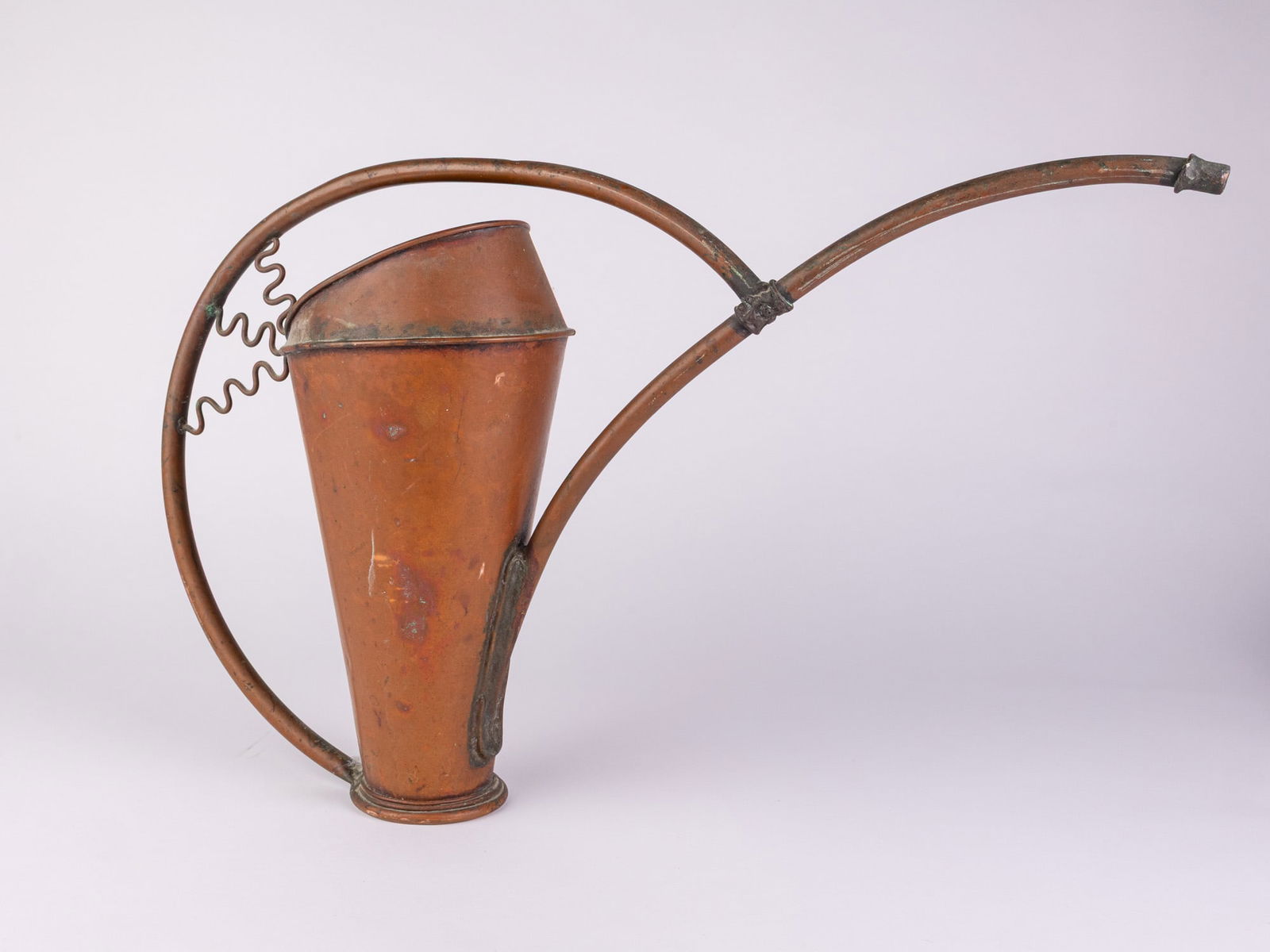 20th c. Copper Watering Can: Artfully constructed from copper, this watering can likely dates to the first half of the 20th century, and features arching, flowing, organic form, with unique squiggle shaped embellishments,