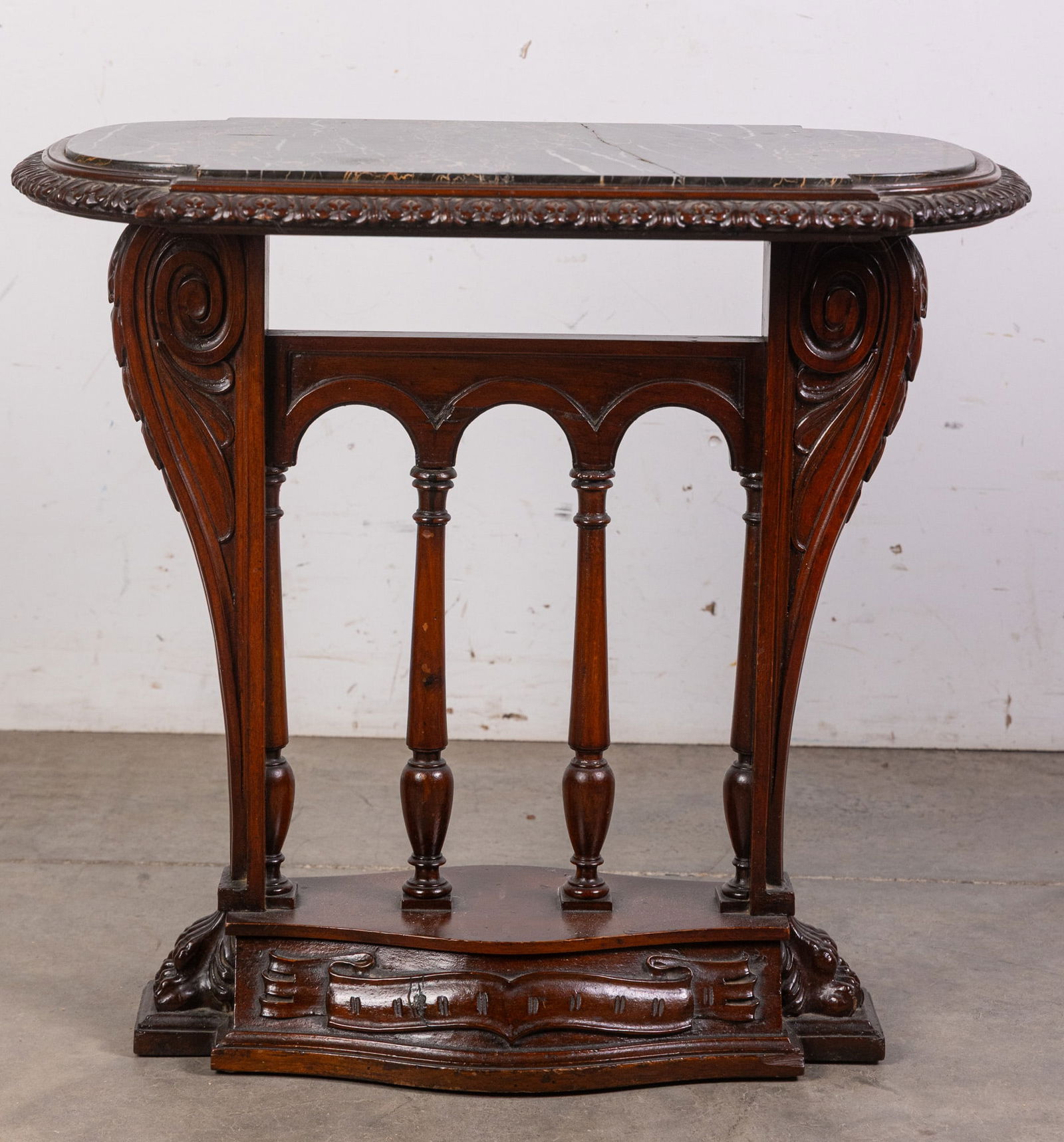 Victorian Claw Foot End Table: This charming little table is the very picture of Victorian elegance, including features such as finely detailed lion's feet, ribbon detail carved in relief, and a unique black marble top with white