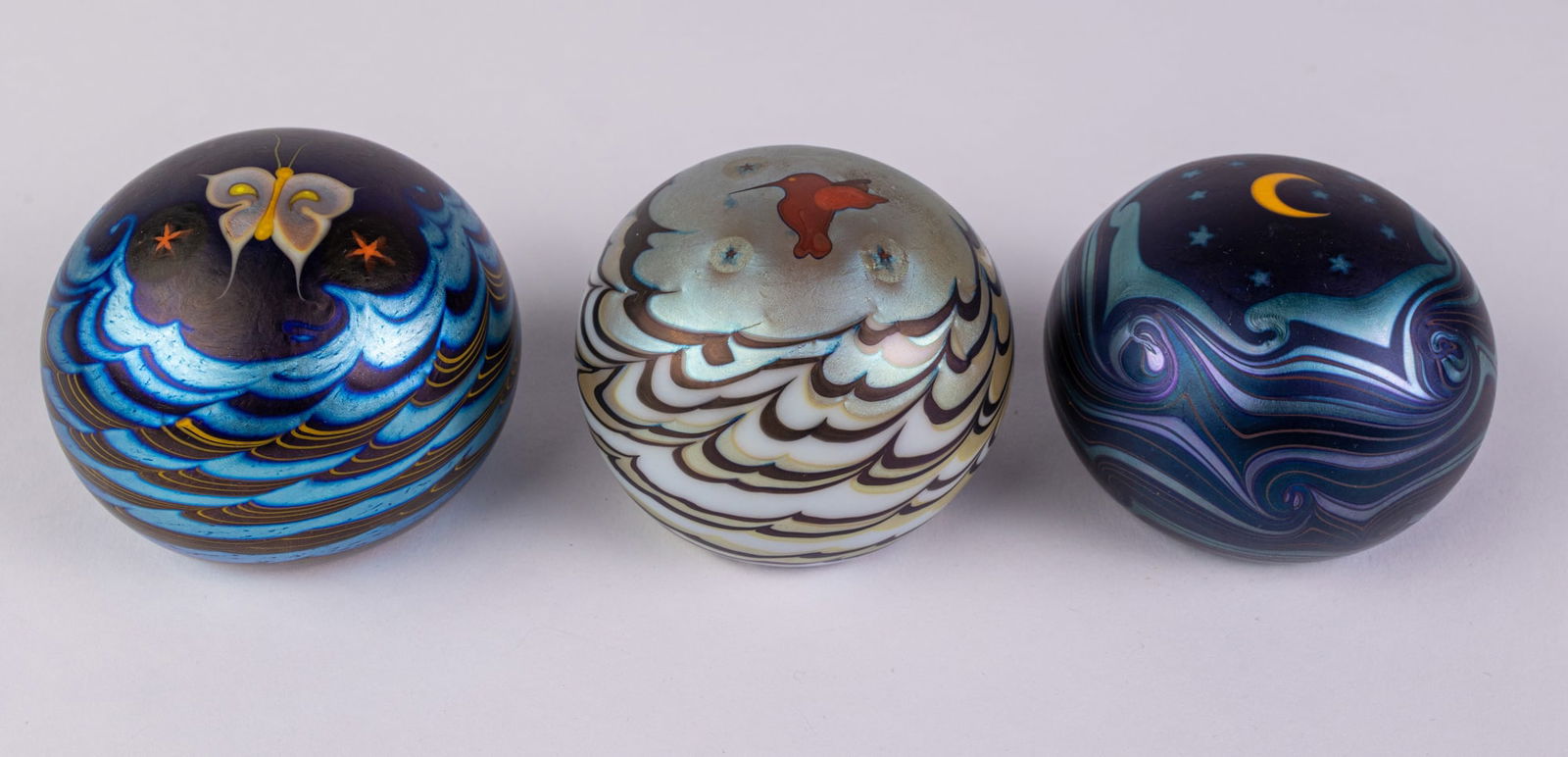 Lundberg Studios | (3) Glass Paperweights: From Lundberg Studios website, "We are a premier art glass manufacturing company. For over 47 years, we have produced some of the finest art glass of our times. Lundberg Studios is located in the