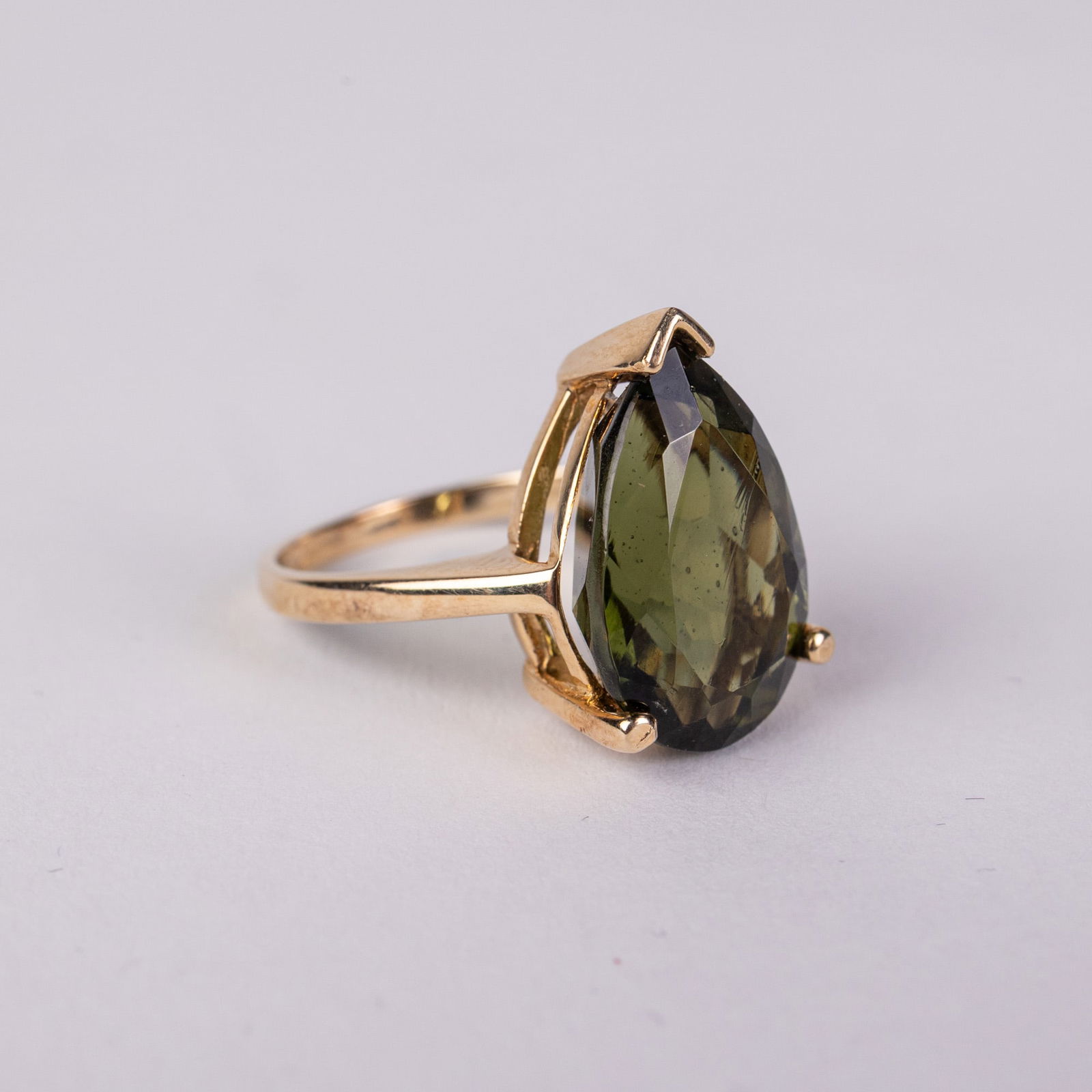 14KY Gold Moldavite Ring: Marked "⌔", size 5, total weight 3.54 grams.LiteratureBrooks Auction – Online Auction Terms & Conditions Contact: (856) 694-2960 | info@brooks.auction READ BEFORE YOU BID: We want you to