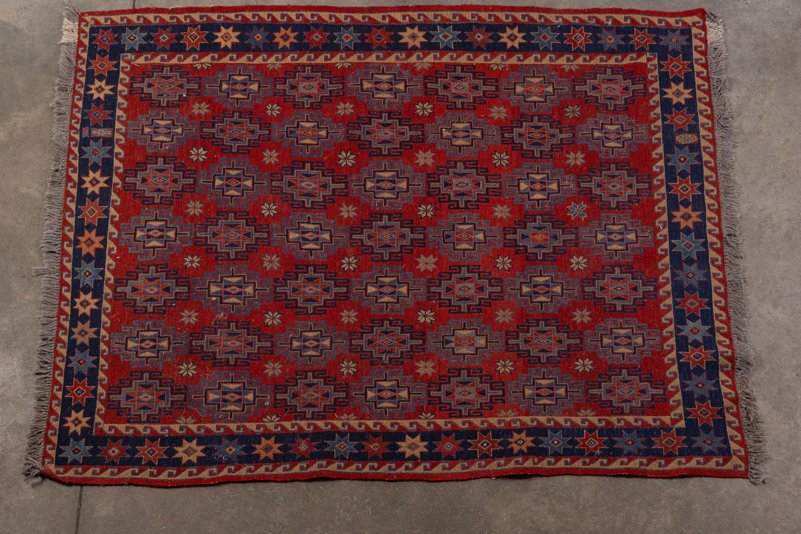 Soumak Kilim Hand Knotted Rug: this flat weave area rug features traditional geometric patterns in a red & blue color palette, seemingly renderings of tribal motifs in natural dyes.Size63" x 50"LiteratureBrooks Auction –