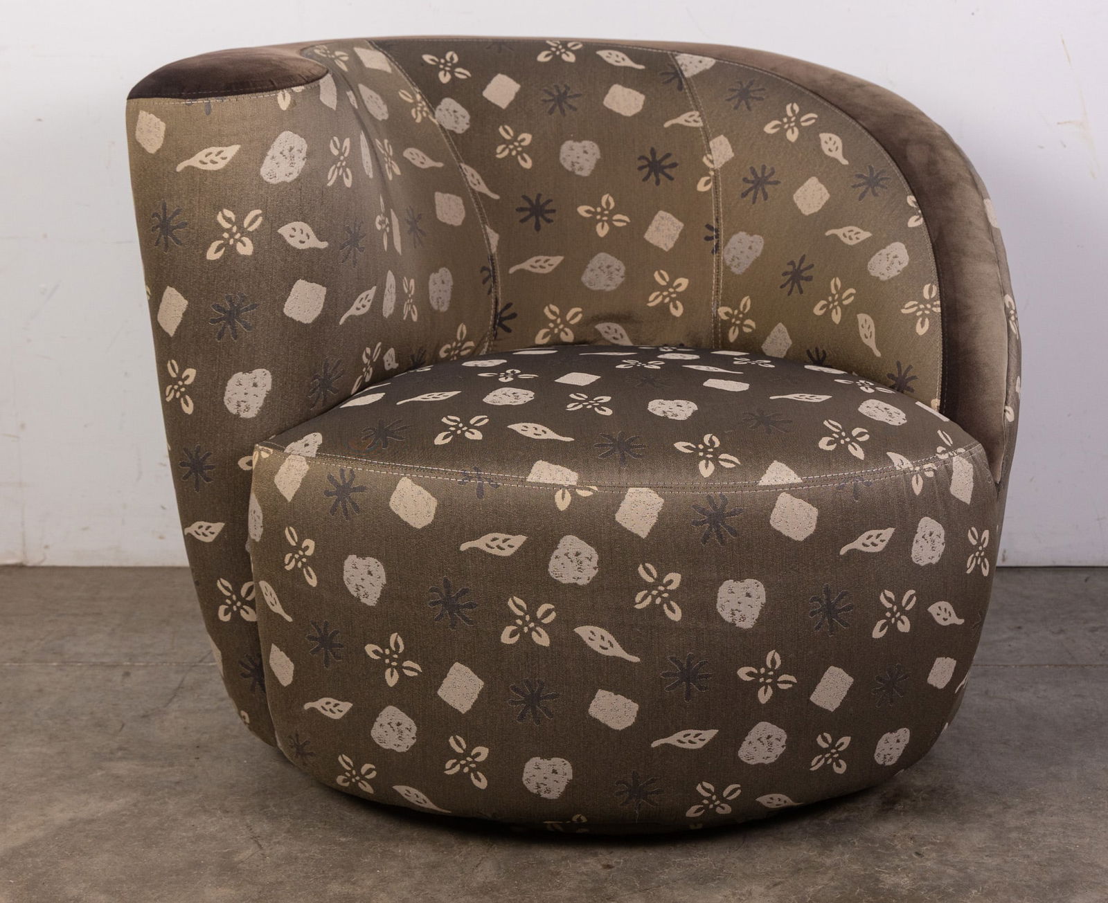 Vladimir Kagan Attr. | "Nautilus" Chair: This "Nautilus" chair has a muted floral and stone motif upholstery evocative of fossils with a suede accent, and corkscrew swivel construction. Size 27" x 36" x 40" Literature Brooks Auction –