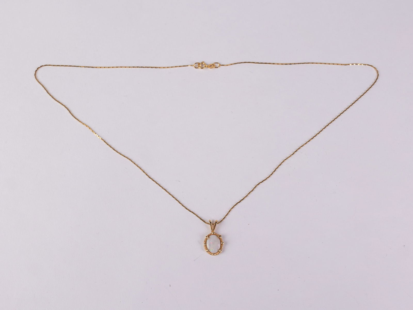14KY Gold Opal Pendant & Necklace: Opal pendant marked "14K" & necklace marked "14K AD", total weight 2.57 grams.LiteratureBrooks Auction – Online Auction Terms & Conditions Contact: (856) 694-2960 | info@brooks.auction READ