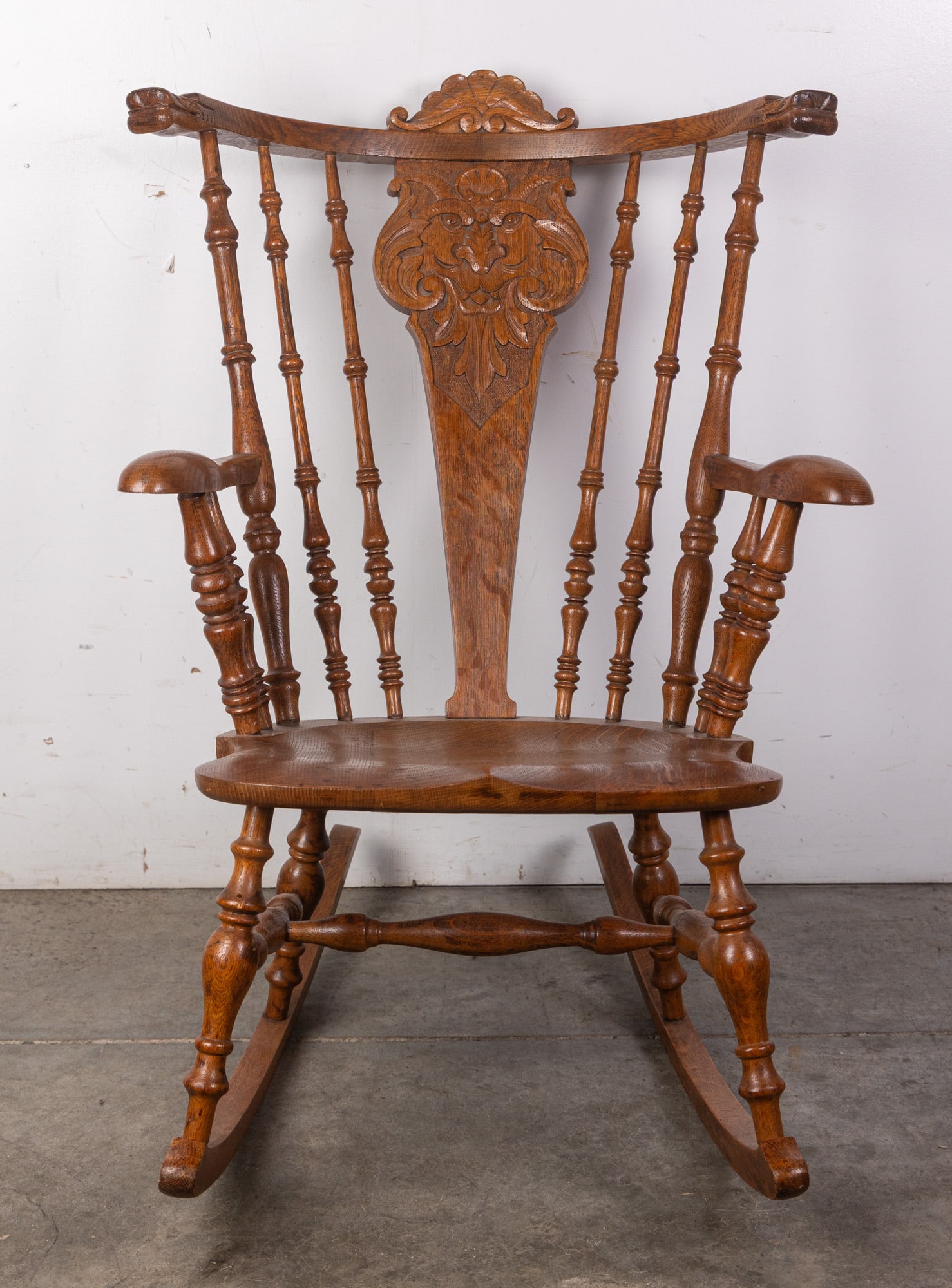 North Wind Golden Oak Figural Rocking Chair: This beautiful antique rocker features hand turned and hand carved construction in its frame. It's figural presence lending itself to be the perfect conversation piece in any home whether connoisseur