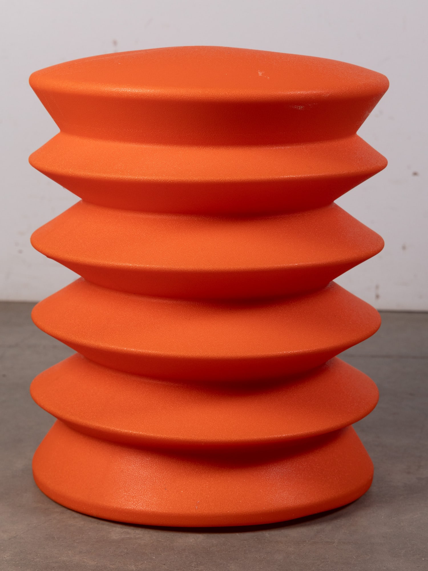Alan Heller | Orange "ErgoErgo" Stool: a vibrant, ergonomic seating solution in bright orange. Its contoured, lightweight form promotes active sitting and flexibility, while the minimalist design allows it to function as a stool, side