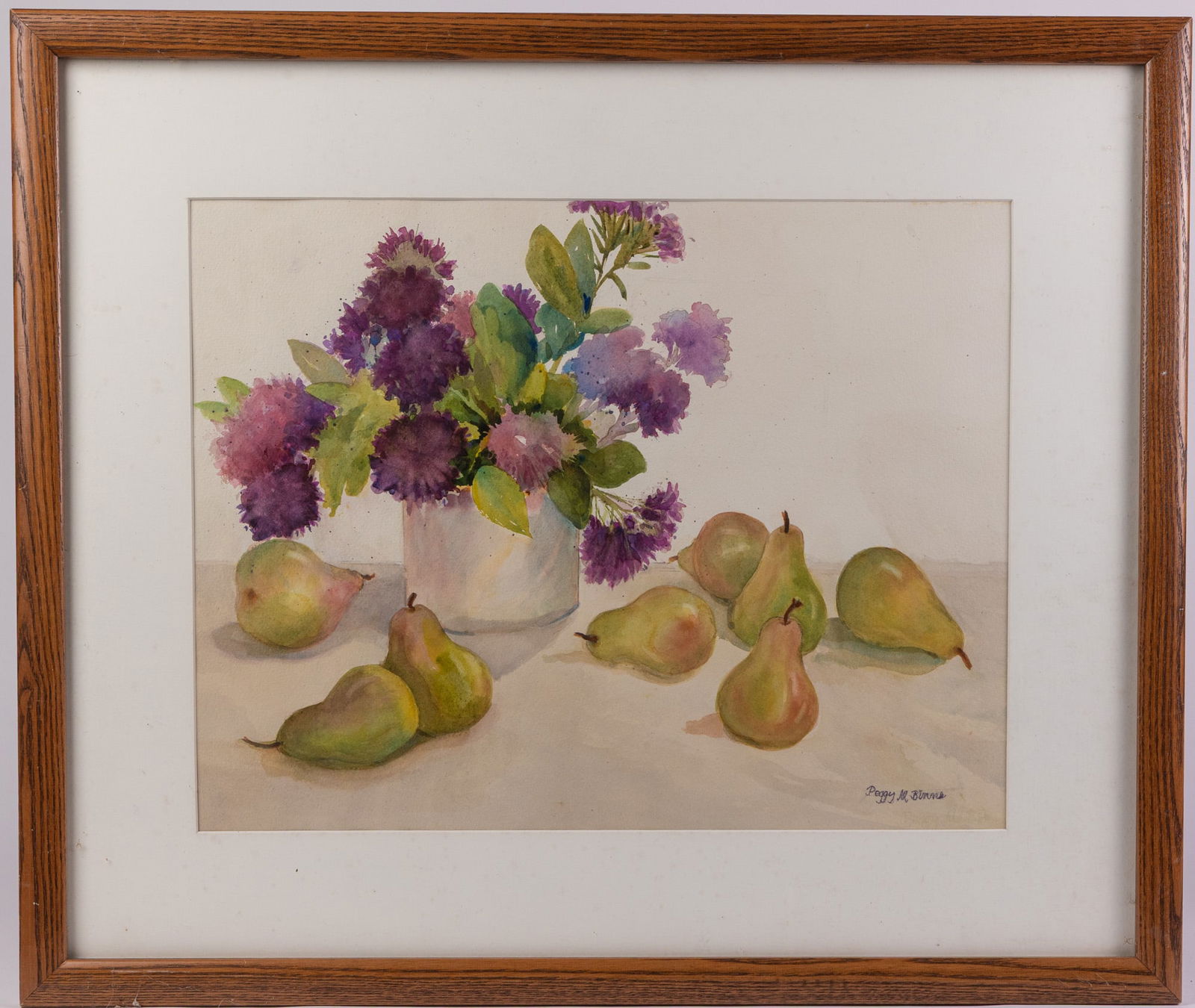 Peggy M. Binns (1926-2021) | Watercolor Still Life: Peggy M. Binns was an American artist from Eastern Pennsylvania known for her watercolor paintings. In this piece, a vivid arrangement of purple flowers contrasts with ripe green pears. It has been