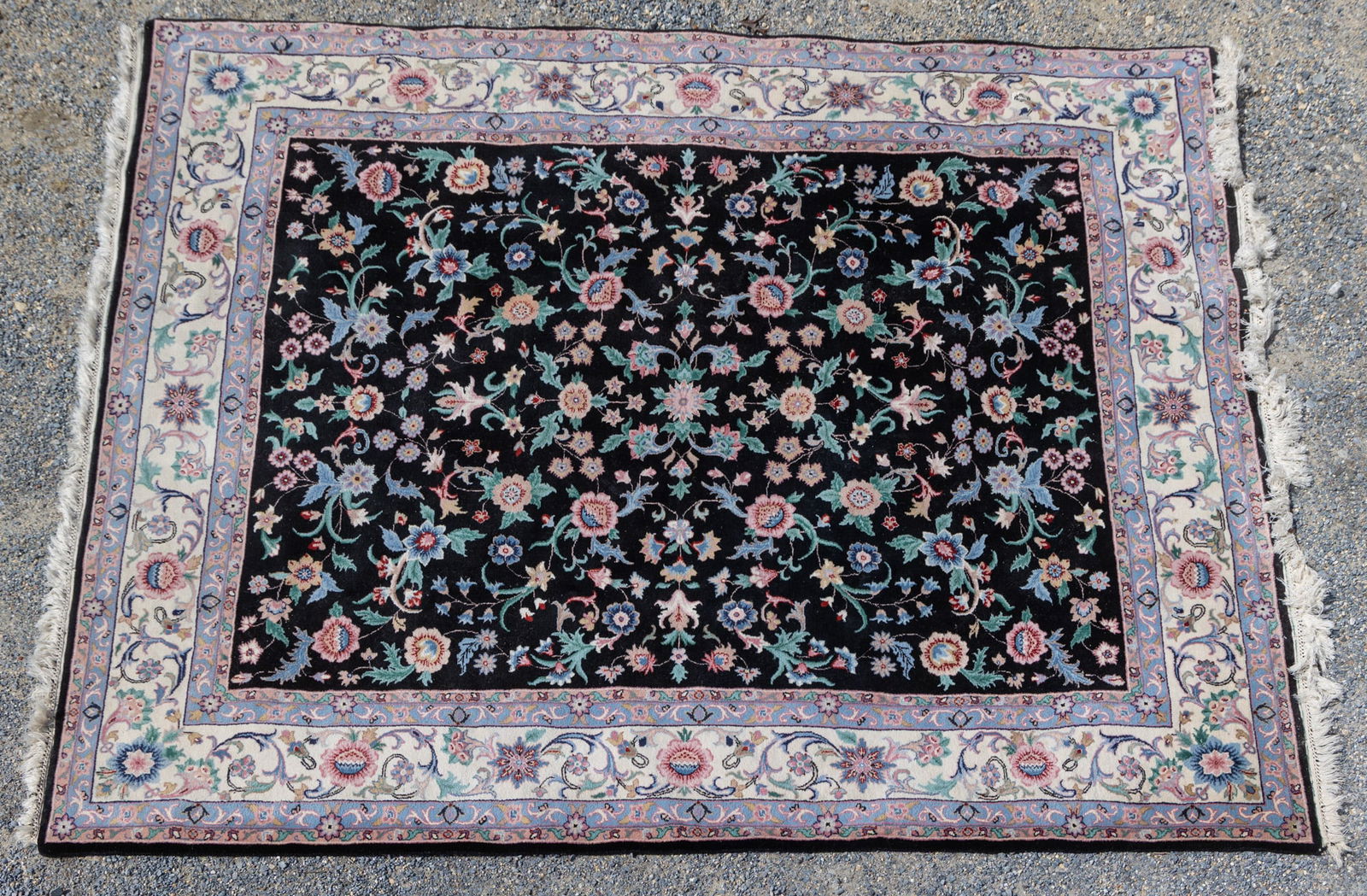 Multi-Colored Floral Oriental Area Rug: This rug features multi-colored floral patterning on a black background with a cream border and tassels on the edges.Size118" x 95"LiteratureBrooks Auction – Online Auction Terms & Conditions