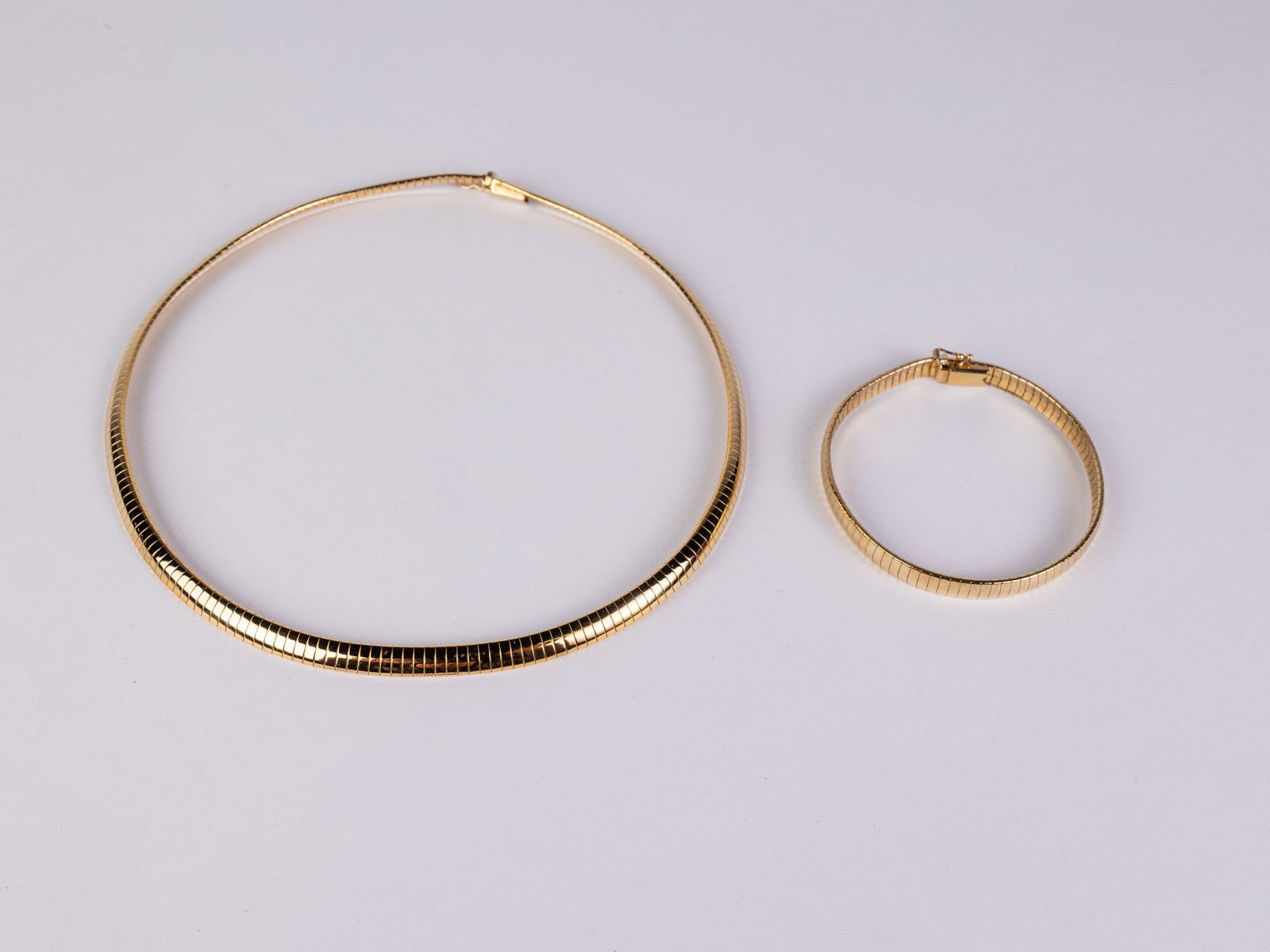 Gold Over Sterling Omega Necklace & Bracelet: Marked "HCT 925 925 Italy", total weight 48.75 grams.LiteratureBrooks Auction – Online Auction Terms & Conditions Contact: (856) 694-2960 | info@brooks.auction READ BEFORE YOU BID: We want you