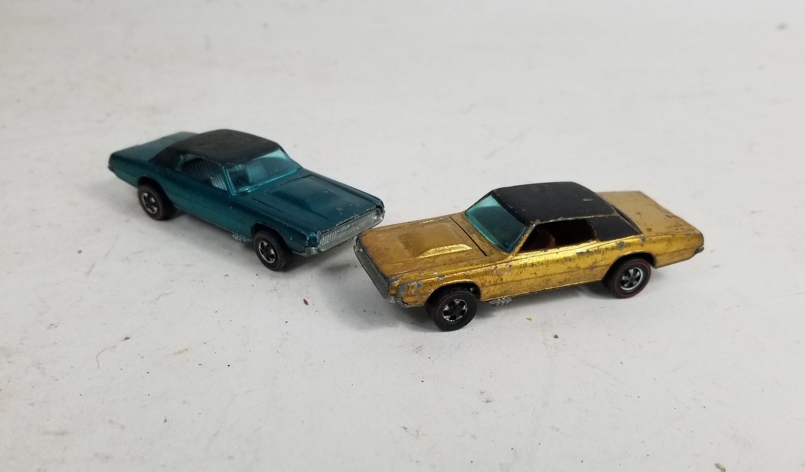 Pair of Hot Wheels Redline Spectraflame Custom T-Bird Cars: Pair of Hot Wheels Redline Spectraflame Custom T-Bird Cars featuring rare green with silver interior and gold models.LiteratureBrooks Auction – Online Auction Terms & Conditions Contact: (856)