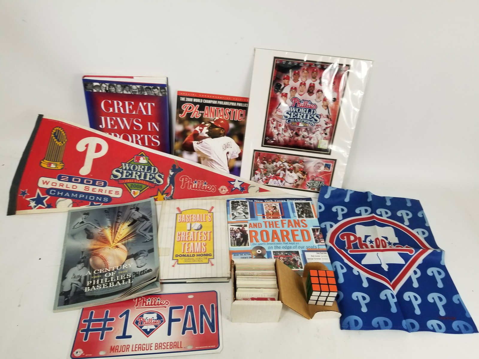 Assortment of Sports Literature and Memorabilia: Assortment of Sports Literature and Memorabilia featuring sports cards and Phillies pennant flag Literature Brooks Auction – Online Auction Terms & Conditions Contact: (856) 694-2960 | info@broo