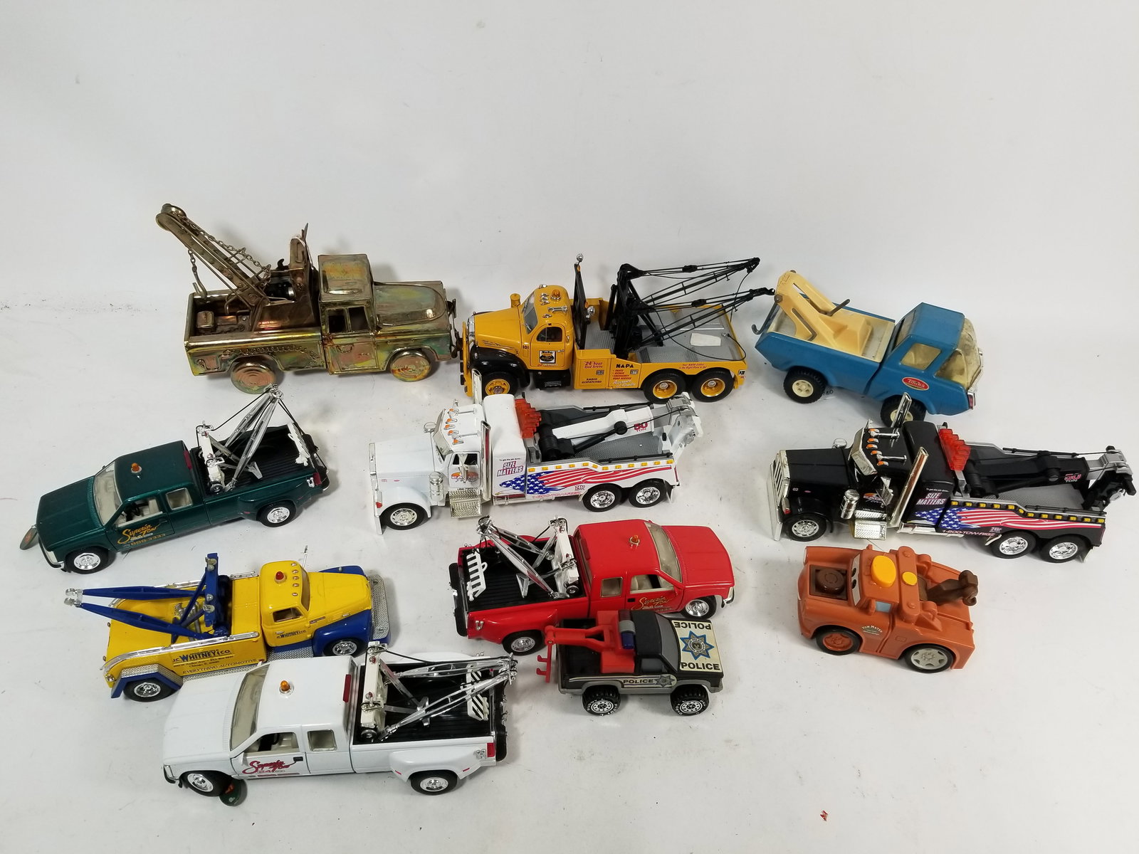 Assortment of Toy and Model Wrecker Tow Trucks: Assortment of Toy and Model Wrecker Tow Trucks featuring Tonka, Sunnyside and First Gear. Literature Brooks Auction – Online Auction Terms & Conditions Contact: (856) 694-2960 | info@brooks.auct