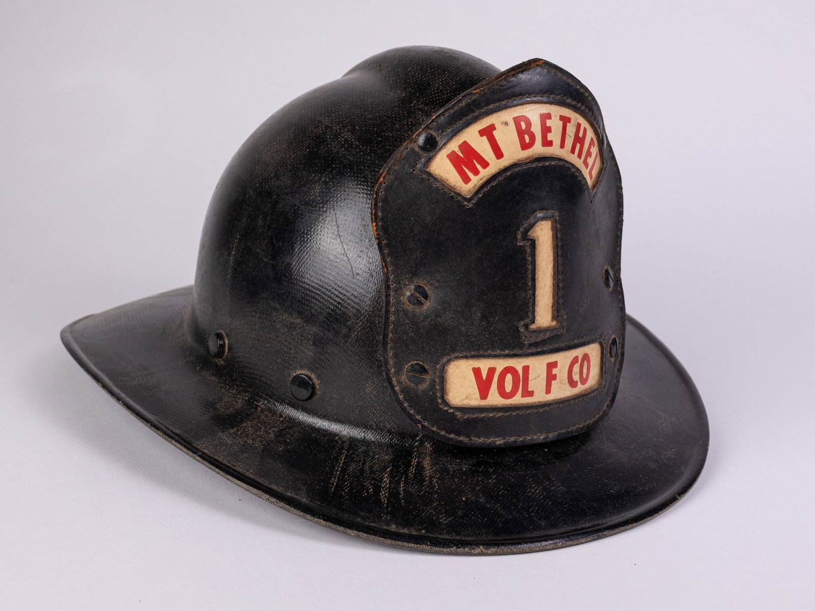Vintage "Mt Bethel Vol F Co" Fire Department Helmet: Vintage "Mt Bethel Vol F Co" Fire Department HelmetSize7" x 12" x 15"LiteratureBrooks Auction – Online Auction Terms & Conditions Contact: (856) 694-2960 | info@brooks.auction READ BEFORE YOU