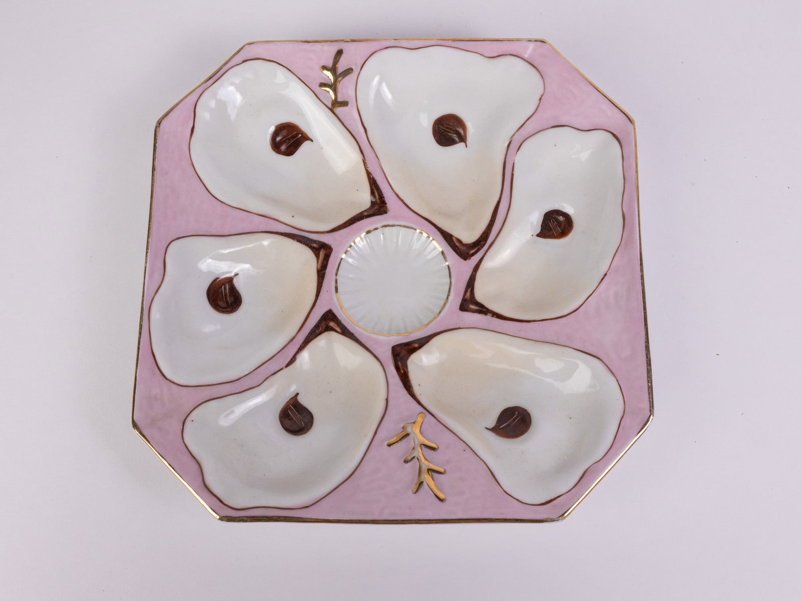 Antique Porcelain Pink & Gold 6-Well Oyster Plate: Antique Porcelain Pink & Gold 6-Well Oyster Plate Size 8" x 8" Literature Brooks Auction – Online Auction Terms & Conditions Contact: (856) 694-2960 | info@brooks.auction READ BEFORE YOU BID