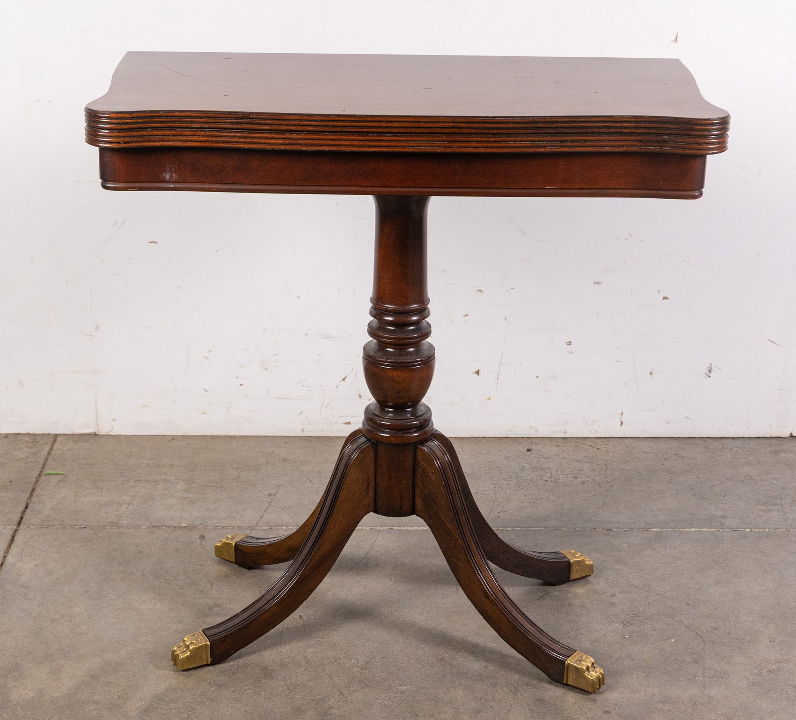 Antique Flip Top Game Table with Brass Clawfoot Detail: Antique Flip Top Game Table with Brass Clawfoot DetailSize29" x 29" x 14"LiteratureBrooks Auction – Online Auction Terms & Conditions Contact: (856) 694-2960 | info@brooks.auction READ BEFORE