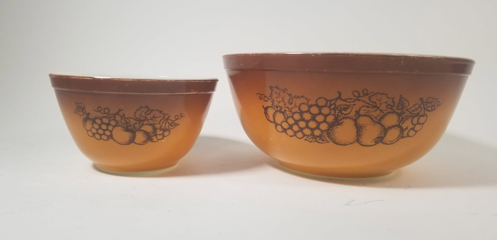 Two Pyrex "Old Orchard" Mixing Bowls: Two Pyrex "Old Orchard" Mixing BowlsSize4" x 9" diameterLiteratureBrooks Auction – Online Auction Terms & Conditions Contact: (856) 694-2960 | info@brooks.auction READ BEFORE YOU BID: We want