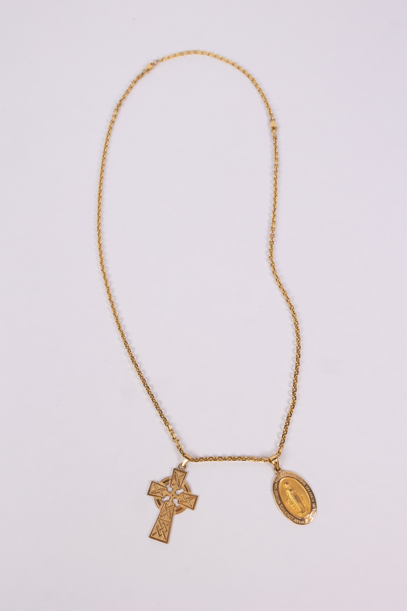Yellow Chain Marked 14K with Two Pendants: Yellow Chain Marked 14K with Two Pendants one of the irish cross and the other of the virgin mary total weight 14.3g Literature Brooks Auction – Online Auction Terms & Conditions Contact: (856) 