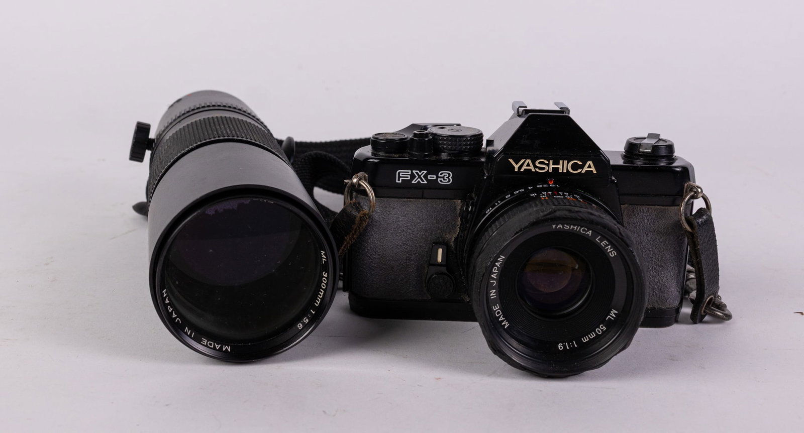 Yashica FX-3 Camera with ML 300mm 1:5.6 Lens: Yashica FX-3 Camera with ML 300mm 1:5.6 Lens, shutter is jammed Size 7" x 12" x 12" Literature Brooks Auction – Online Auction Terms & Conditions Contact: (856) 694-2960 | info@brooks.auction