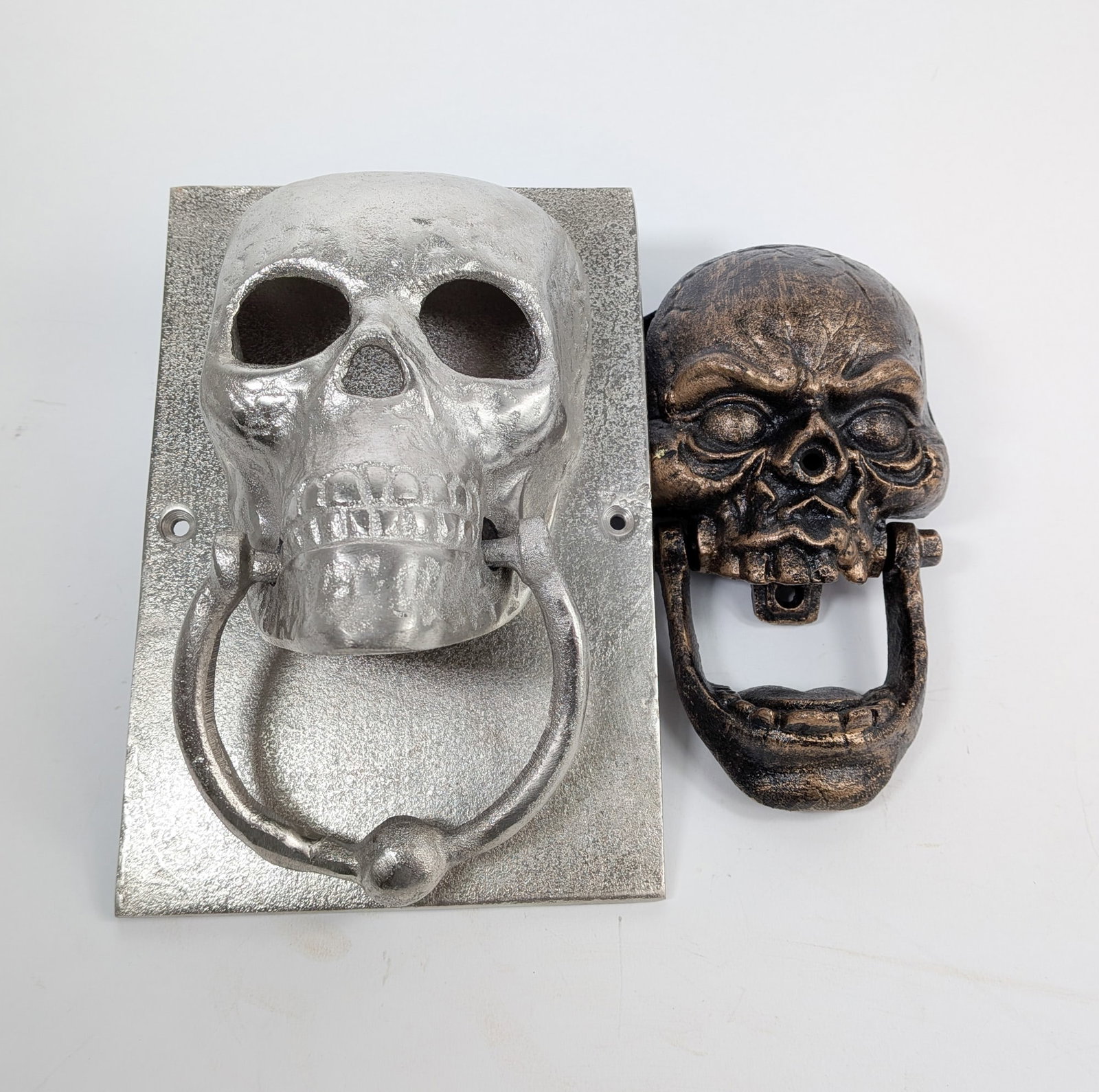Two Skull Form Door Knockers: Two Skull Form Door Knockers Size 8" x 6" x 4" Literature Brooks Auction – Online Auction Terms & Conditions Contact: (856) 694-2960 | info@brooks.auction READ BEFORE YOU BID: We want you to