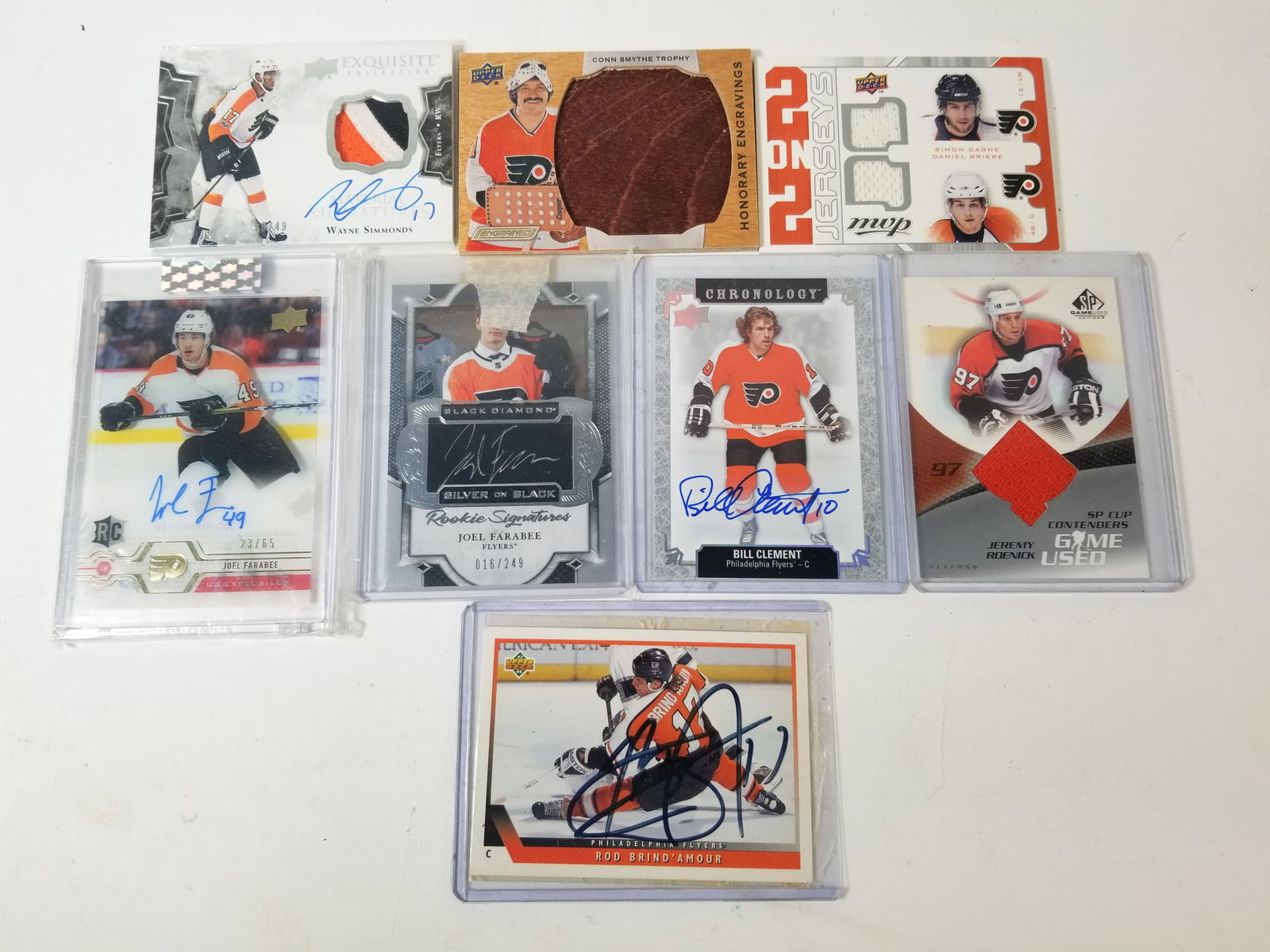 Assortment of Flyers Autograph and Relic Cards: Assortment of Flyers Autograph and Relic Cards featuring autographs of Bill Clement and Rod Brind'Amour along with quad relic including Alex Ovechkin. Size 7" x 12" x 12" Literature Brooks Auction