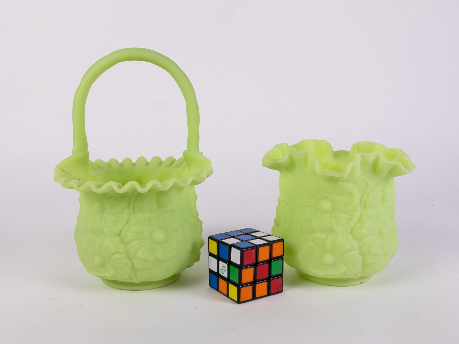 Two Pieces of Fenton "Poppy" Uranium Satin Custard Art Glass: Two Pieces of Fenton "Poppy" Uranium Satin Custard Art Glass: one piece has chips/cracks in the base pictured Size 10" x 7" x 5" Literature Brooks Auction – Online Auction Terms & Conditions