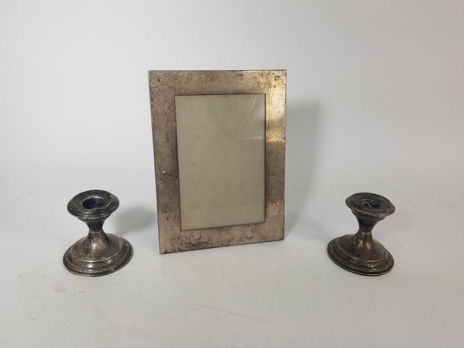 Candle Sticks and Picture Frame Marked Sterling: Candle Sticks and Picture Frame Marked Sterling the frame weighs 83.g and the candle holders 315.5g Literature Brooks Auction – Online Auction Terms & Conditions Contact: (856) 694-2960 |