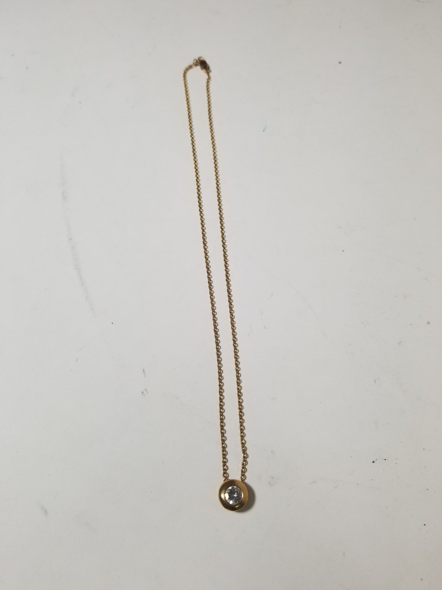 Yellow Chain Marked 14k with a white stone Pendant: Yellow Chain Marked 14k with a white stone Pendant total Literature Brooks Auction – Online Auction Terms & Conditions Contact: (856) 694-2960 | info@brooks.auction READ BEFORE YOU BID: We want