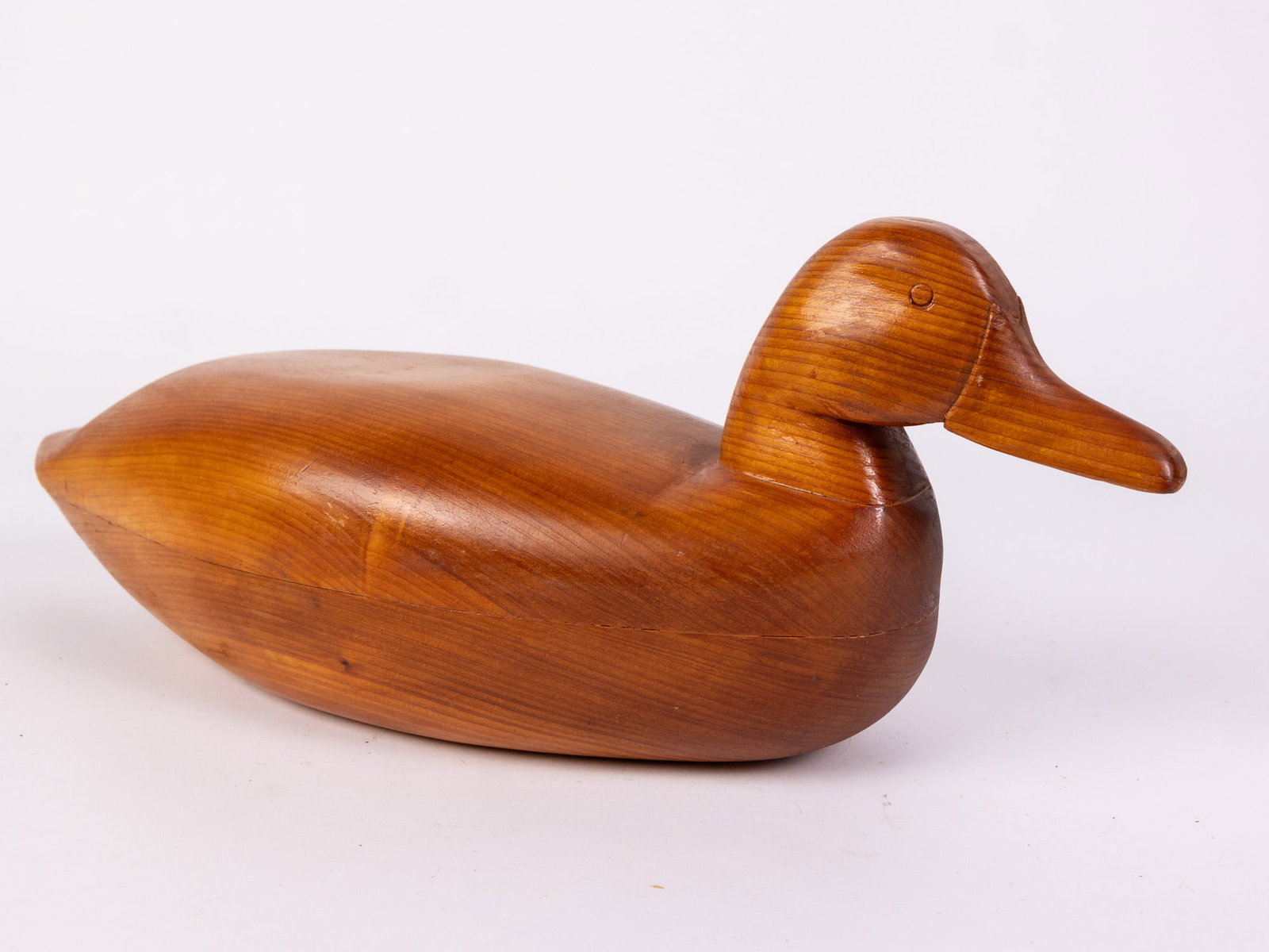 Vintage Hand Carved Duck Decoy w/ Natural Wood Finish: Crafted from wood, with a smooth stained finish and prominent wood grain throughout Size 6.5" x 6" x 17" Literature Brooks Auction – Online Auction Terms & Conditions Contact: (856) 694-2960 |