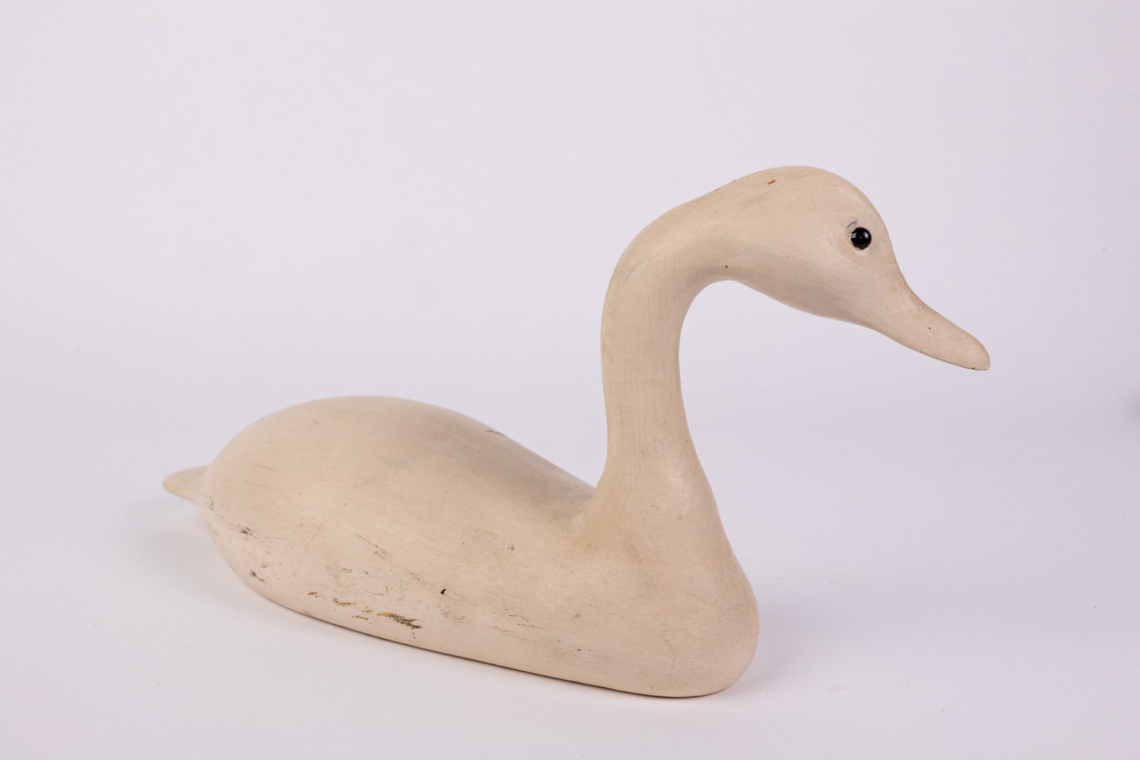 Vintage Carved Wooden Duck Decoy: Unknown species, decoy is painted fully white with glass eyes. Unsigned. Size 7" x 6" x 14" Literature Brooks Auction – Online Auction Terms & Conditions Contact: (856) 694-2960 | info@brooks.a