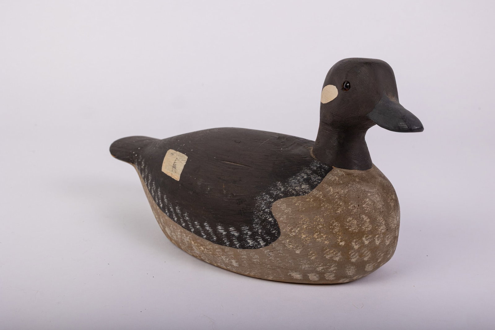 Vintage Bufflehead Hen Duck Decoy: Hand painted and carved from wood with glass eyes. Unsigned. Size 6" x 6" x 11" Literature Brooks Auction – Online Auction Terms & Conditions Contact: (856) 694-2960 | info@brooks.auction READ
