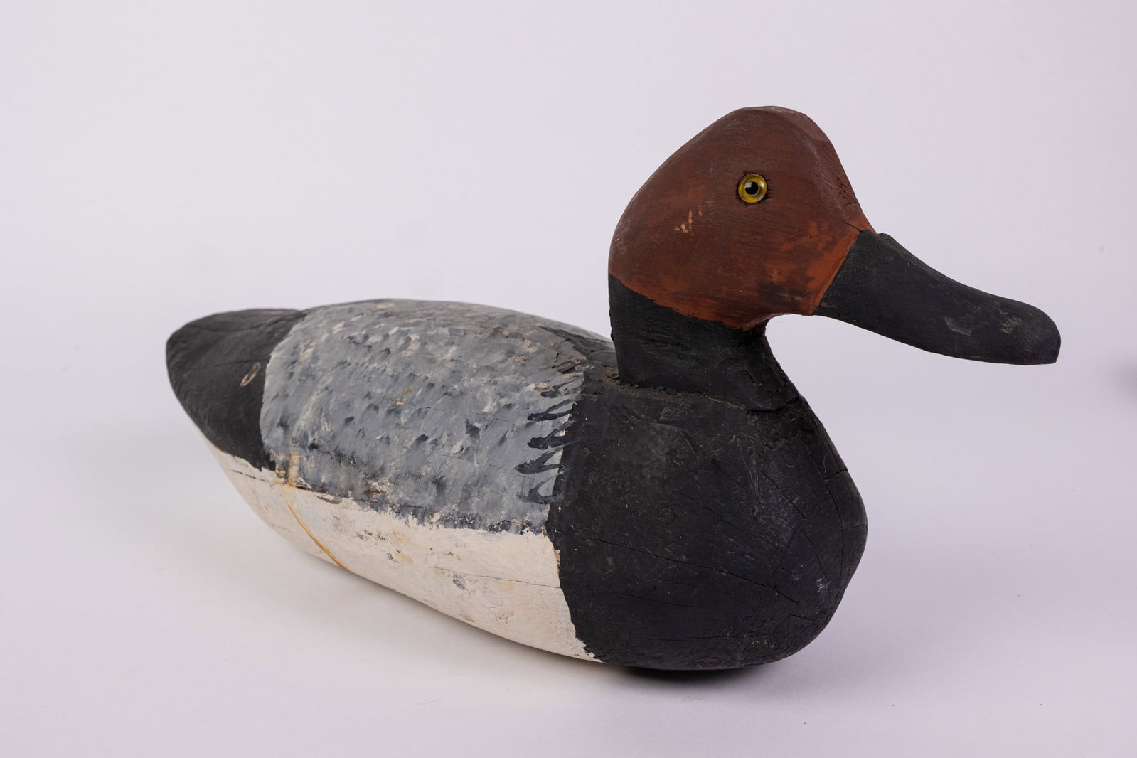 Vintage Canvasback Drake Duck Decoy: Hand painted and carved from wood with glass eyes. Unsigned. Minor wear to paint. Size 7" x 7" x 14" Literature Brooks Auction – Online Auction Terms & Conditions Contact: (856) 694-2960 |