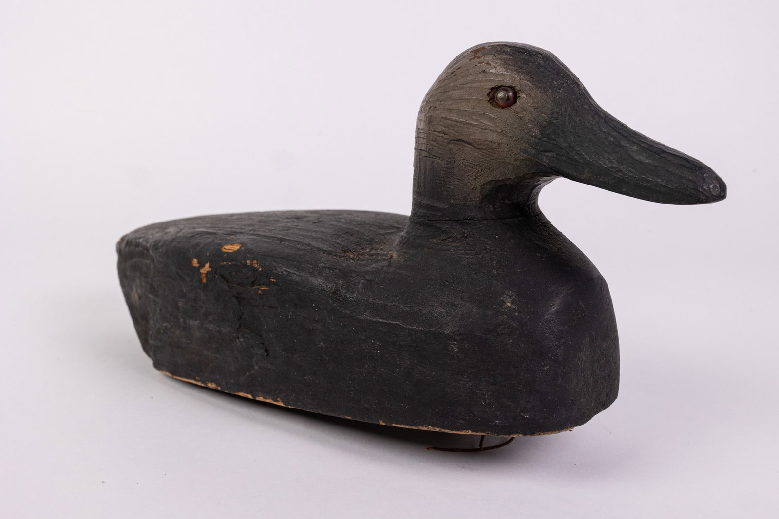 Vintage Black Duck Hen Decoy: Hand painted with minimal detail, glass eyes. Unsigned. Size 7" x 5" x 12" Literature Brooks Auction – Online Auction Terms & Conditions Contact: (856) 694-2960 | info@brooks.auction READ BE