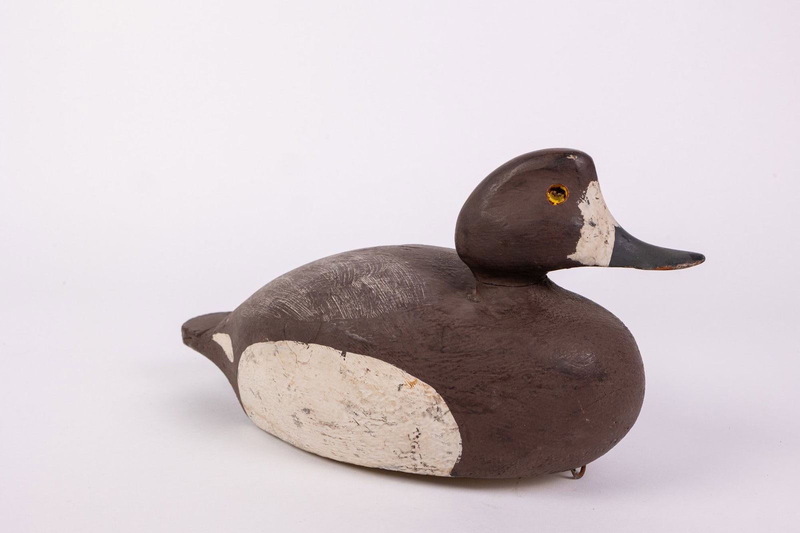 Vintage Bufflehead Hen Duck Decoy: Unsigned, lead weighted. Missing one glass eye Size 6" x 6" x 12" Literature Brooks Auction – Online Auction Terms & Conditions Contact: (856) 694-2960 | info@brooks.auction READ BEFORE YOU