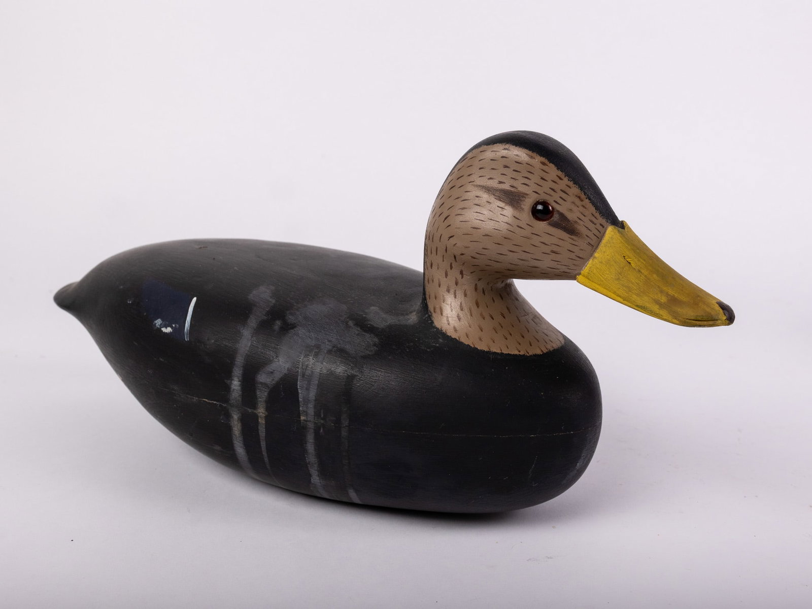 Vintage New Jersey Style Black Duck Decoy: Hand painted and carved from wood with glass eyes. Unsigned. Minor wear to paint. Size 7" x 6" x 15" Literature Brooks Auction – Online Auction Terms & Conditions Contact: (856) 694-2960 | info