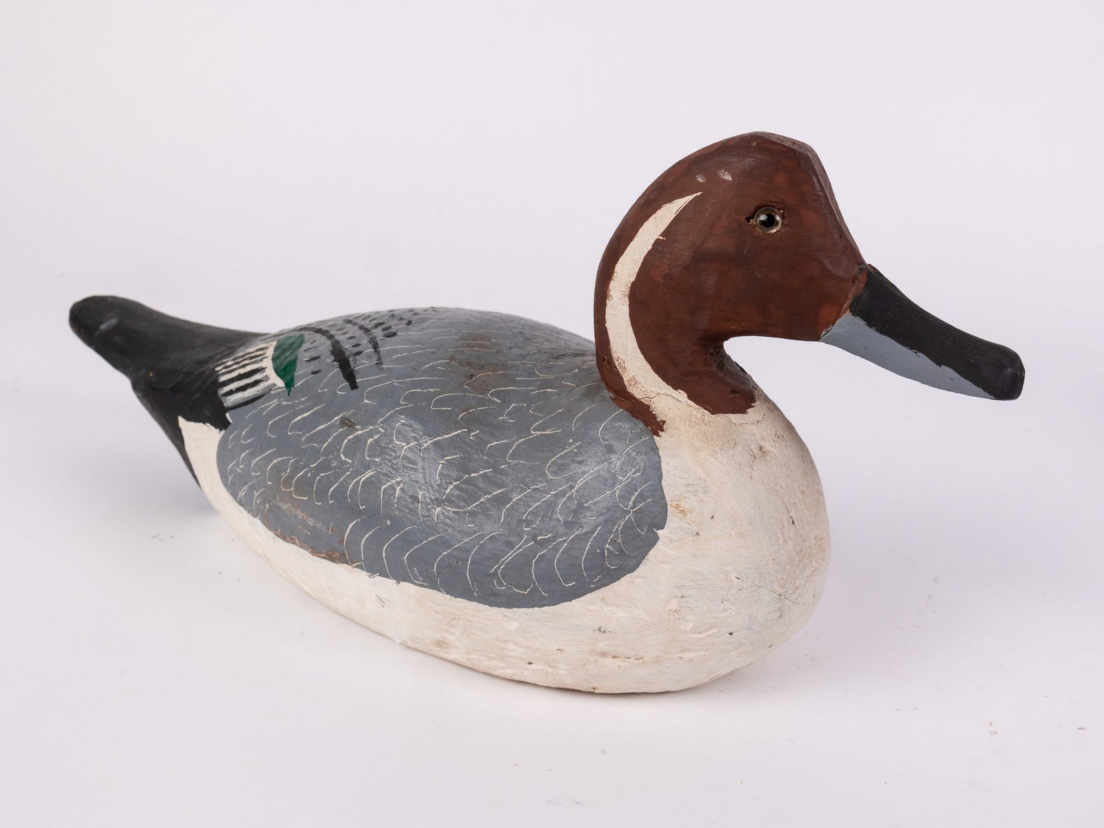 Vintage Pintail Drake Duck Decoy: Hand painted and carved from wood with glass eyes. Unsigned. Minor wear to paint. Size 7" x 6" x 15" Literature Brooks Auction – Online Auction Terms & Conditions Contact: (856) 694-2960 |