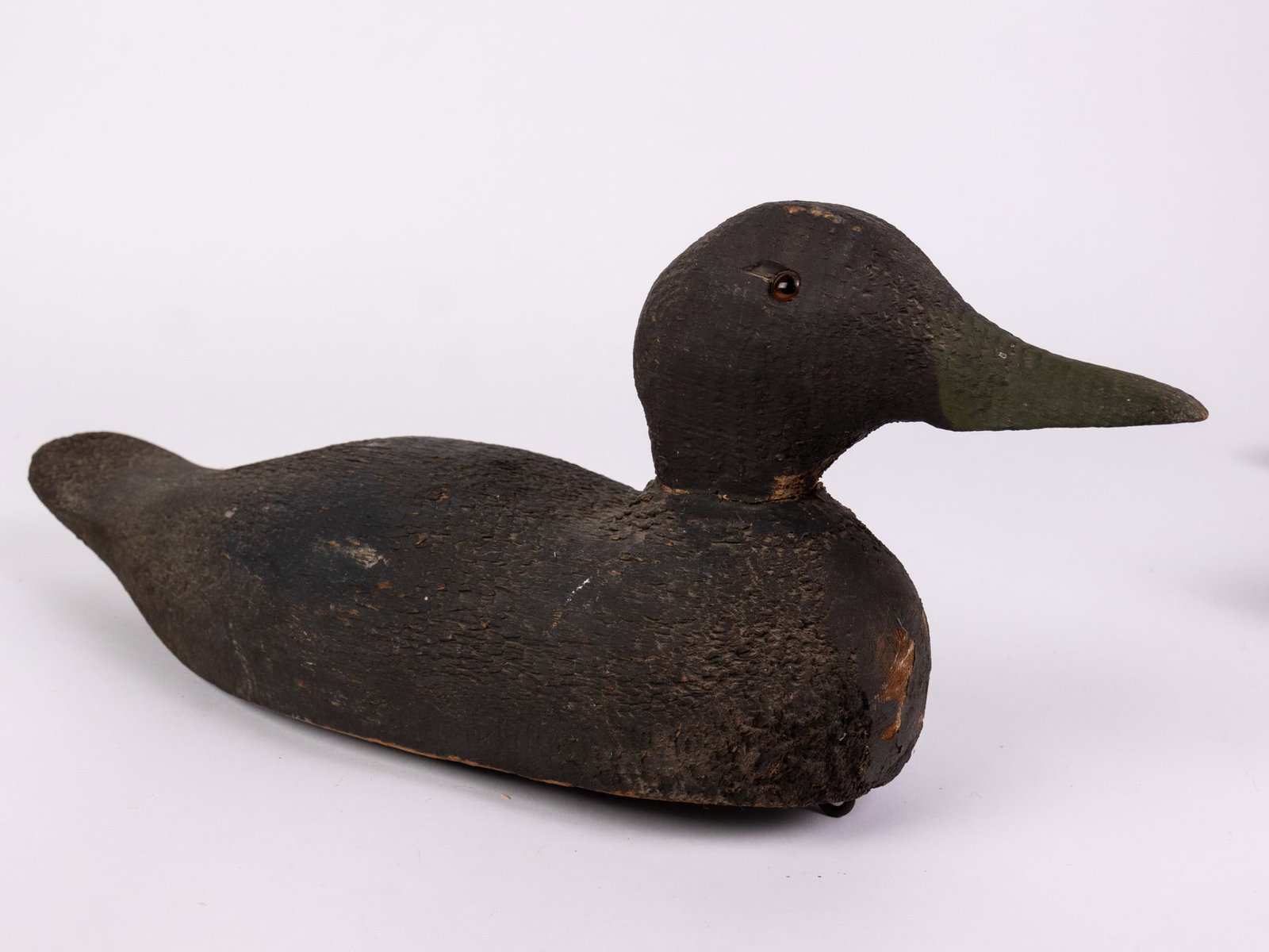 Vintage Wooden Black Duck Decoy: Missing one glass inset eye & wear to paint consistent w/ age Size 6.5" x 5" x 17" Literature Brooks Auction – Online Auction Terms & Conditions Contact: (856) 694-2960 | info@brooks.auction