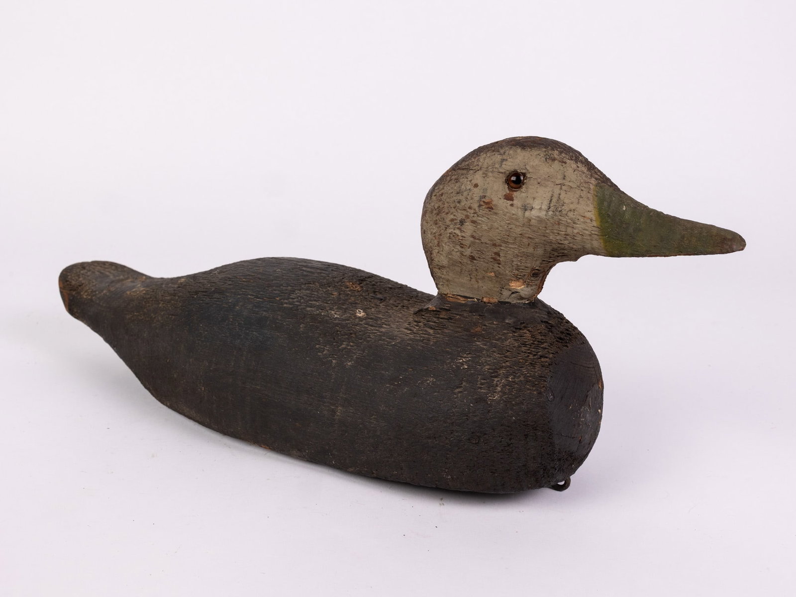 Vintage Wooden Black Duck Decoy: Glass inset eyes & wear to paint consistent w/ age Size 7" x 5" x 16" Literature Brooks Auction – Online Auction Terms & Conditions Contact: (856) 694-2960 | info@brooks.auction READ BEFORE YOU