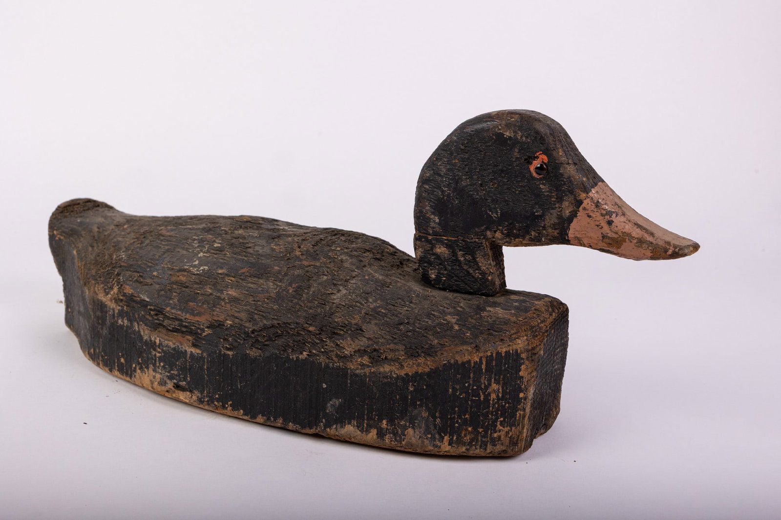 Vintage Wooden Black Duck Decoy: Glass inset eyes & wear to paint consistent w/ age Size 7" x 6" x 17" Literature Brooks Auction – Online Auction Terms & Conditions Contact: (856) 694-2960 | info@brooks.auction READ BEFORE YOU
