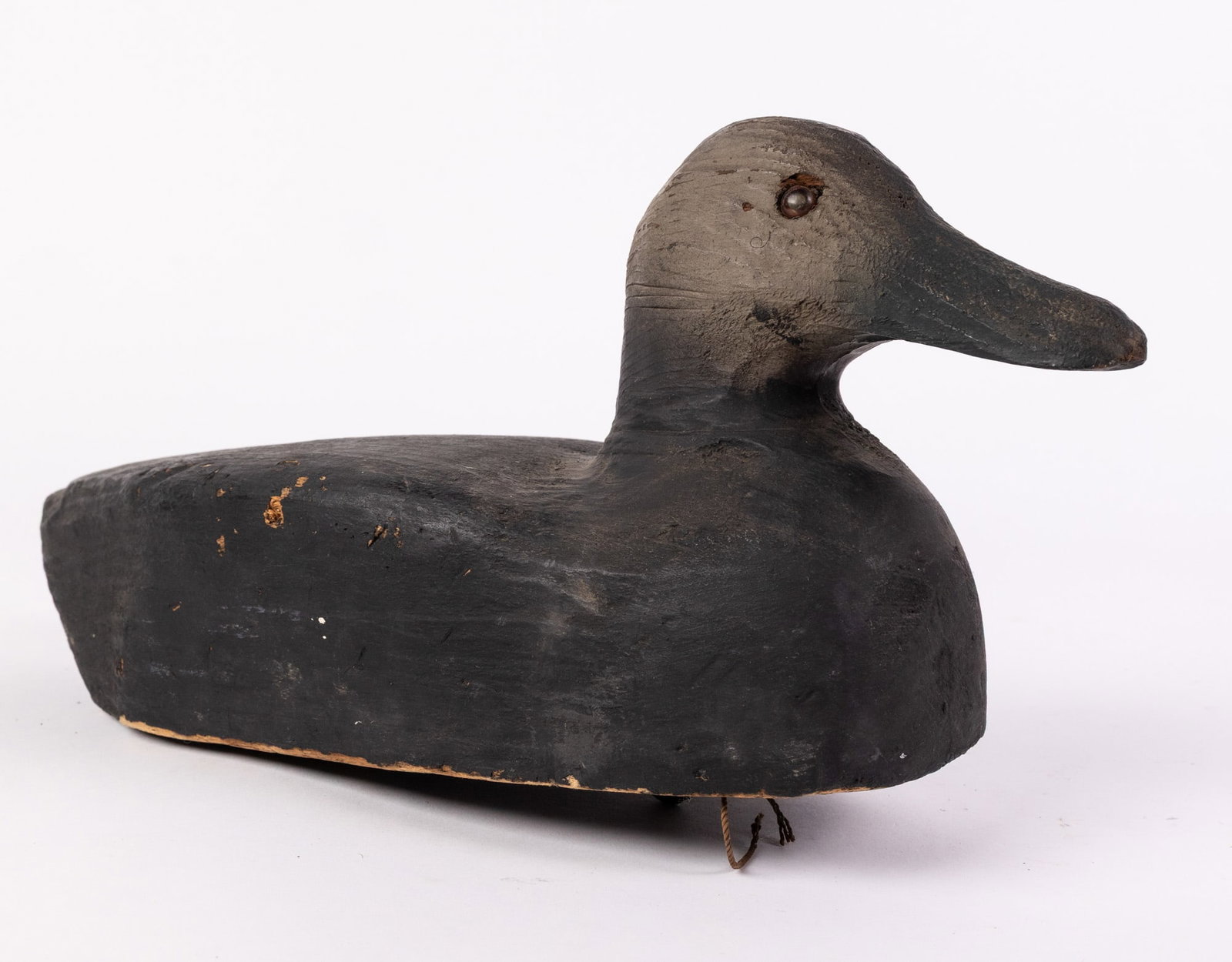 Vintage Wooden Black Duck Decoy: Glass inset eyes & wear to paint consistent w/ age Size 7" x 6" x 17" Literature Brooks Auction – Online Auction Terms & Conditions Contact: (856) 694-2960 | info@brooks.auction READ BEFORE YOU