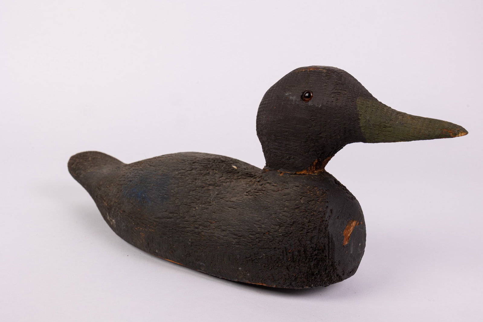 Vintage Wooden Black Duck Decoy: Glass inset eyes & wear to paint consistent w/ age Size 7" x 6" x 17" Literature Brooks Auction – Online Auction Terms & Conditions Contact: (856) 694-2960 | info@brooks.auction READ BEFORE YOU