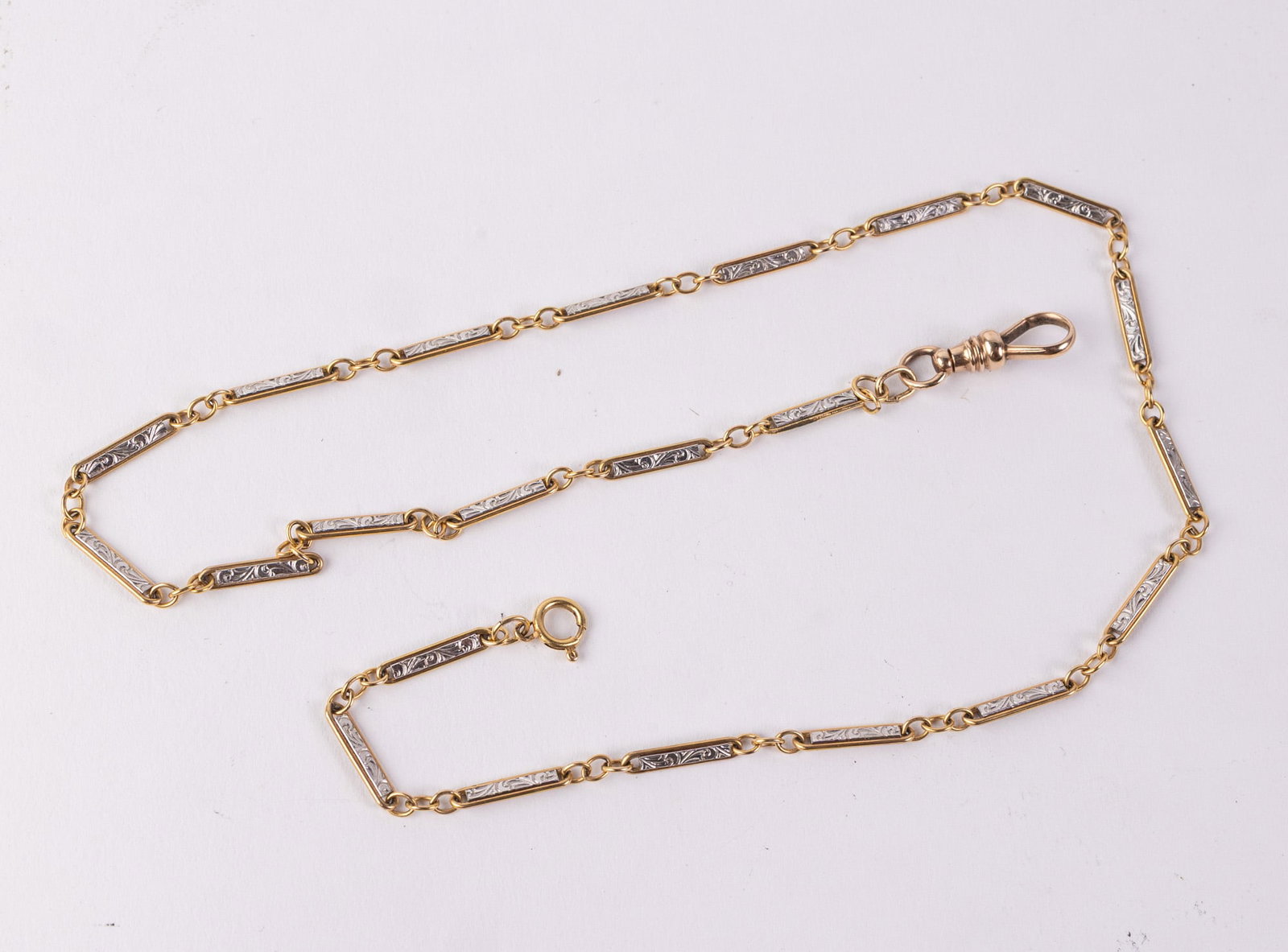 Antique 14KY Gold Bar Link Station Watch Chain w/ 10KY Dog Clip: The chain features intricate art deco engraved details. The chain is marked 14KT on the spring ring clasp. The dog clip is marked 10KT. Total weight is 10.8 grams. Untested. Size 19" Literature Brooks